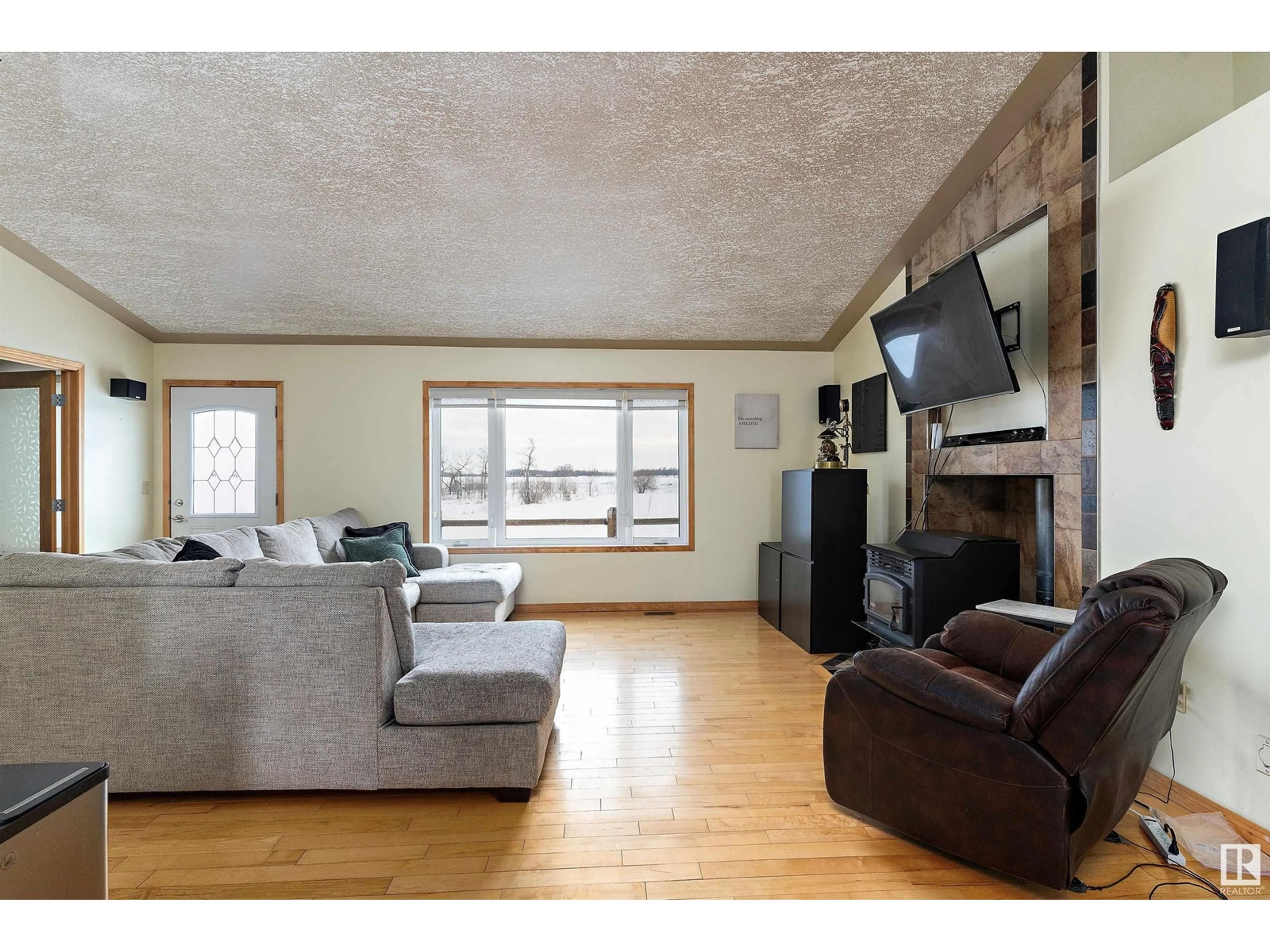 Living room with furniture, wood/laminate floor for 48245 Range Rd 212, Rural Camrose County Alberta T0B0G0