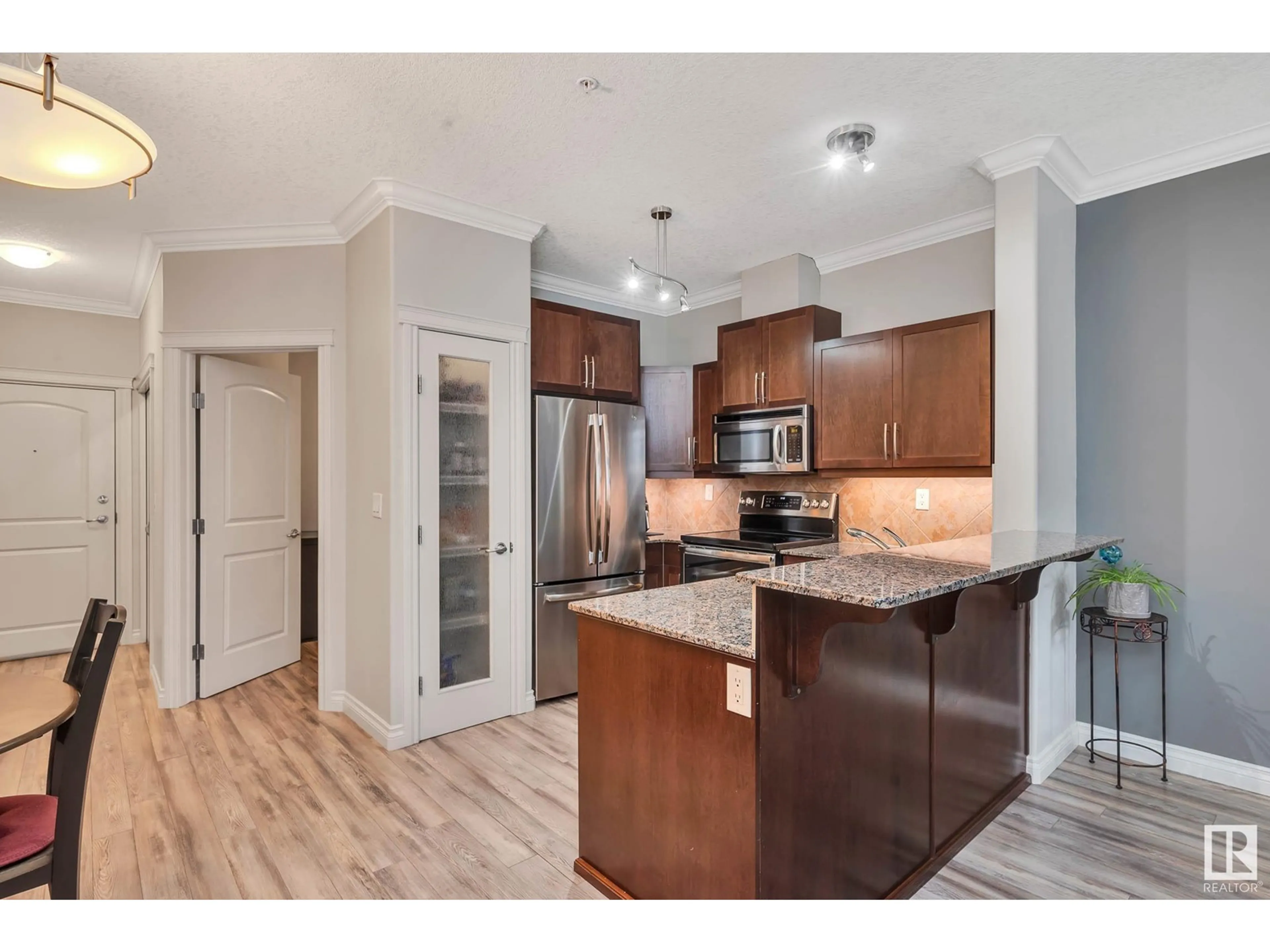 Open concept kitchen, wood/laminate floor for #234 10121 80 AV NW, Edmonton Alberta T6E0B9