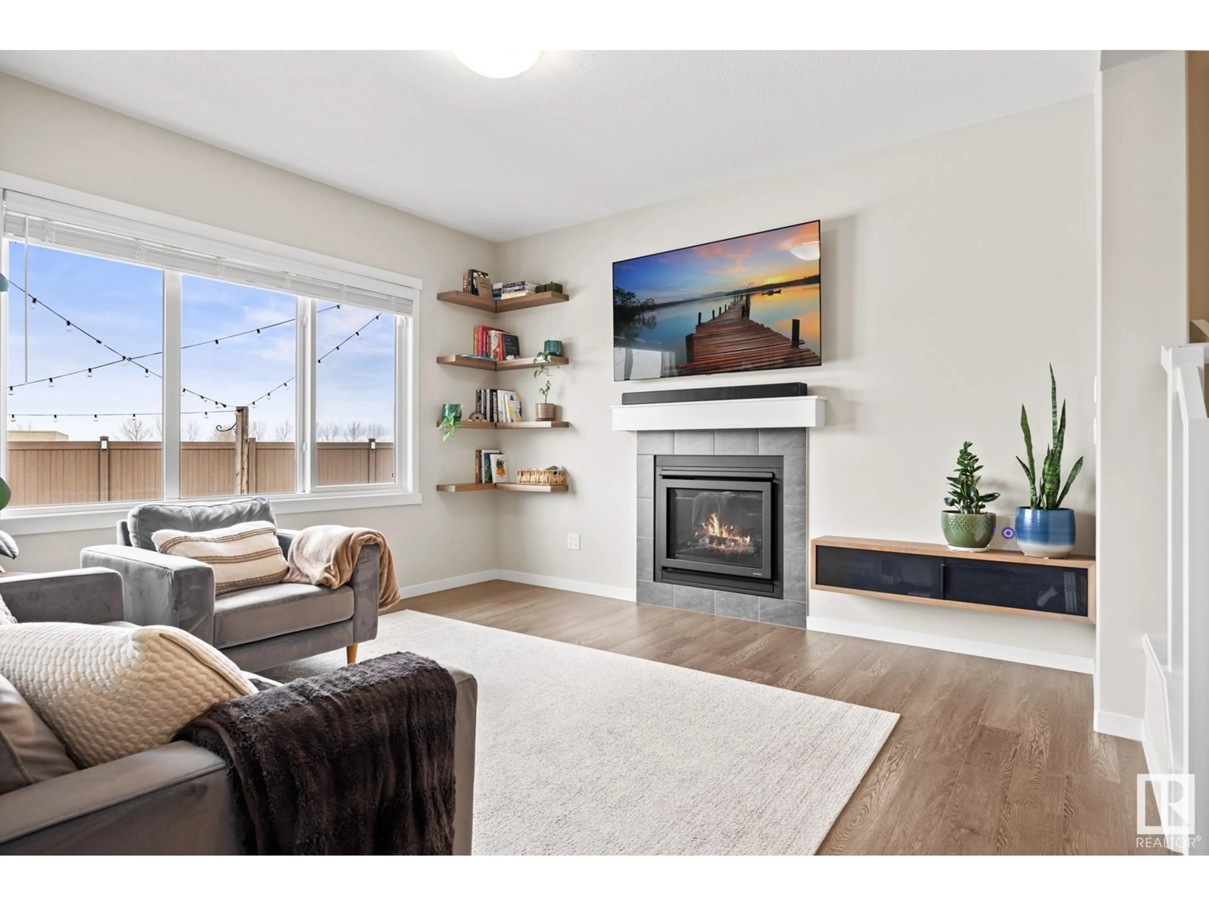 Living room with furniture, wood/laminate floor for 3614 PARKER CL SW, Edmonton Alberta T6W3A9