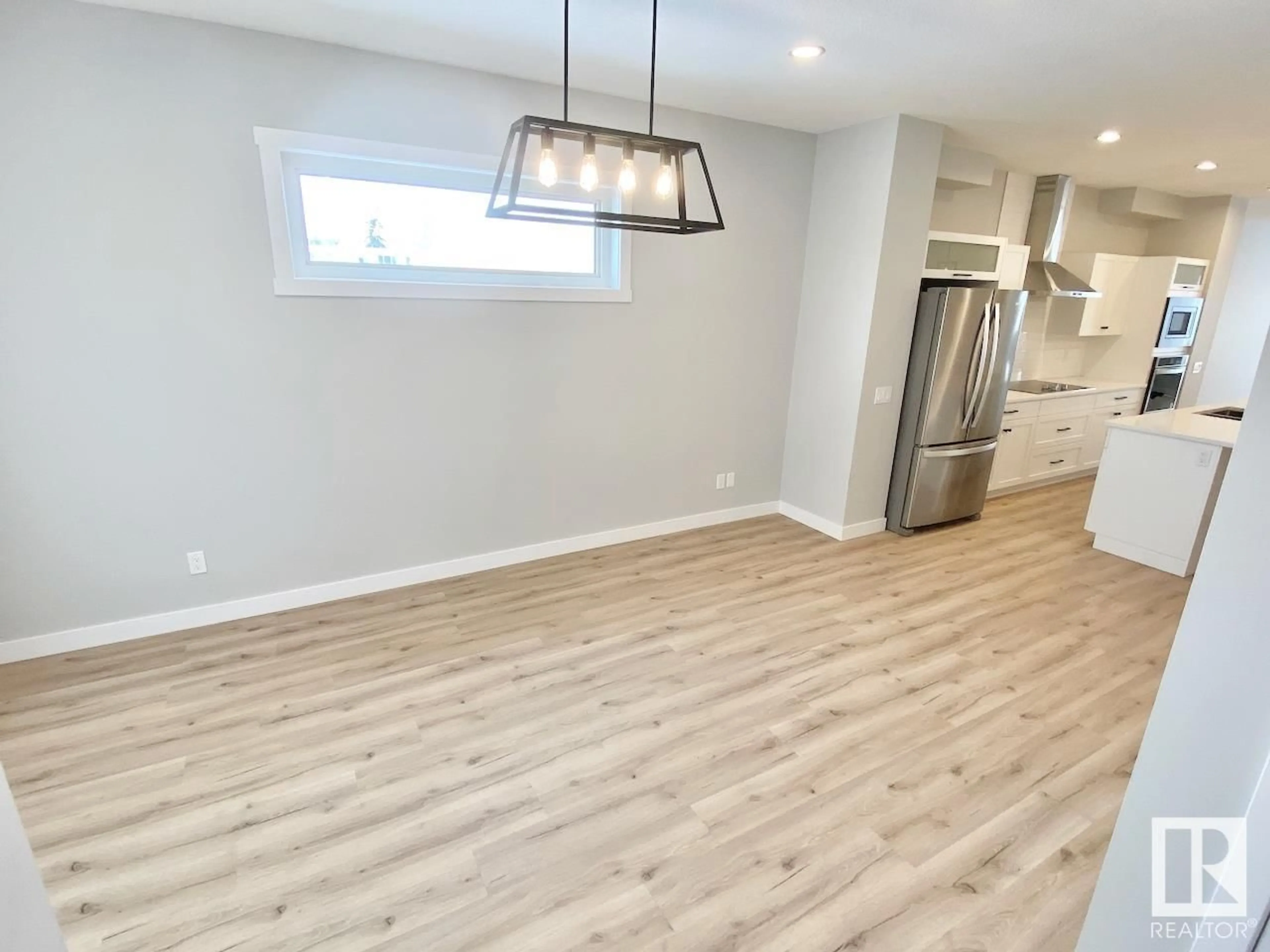 Open concept kitchen, wood/laminate floor for 11739 130 ST NW, Edmonton Alberta T5M1A9