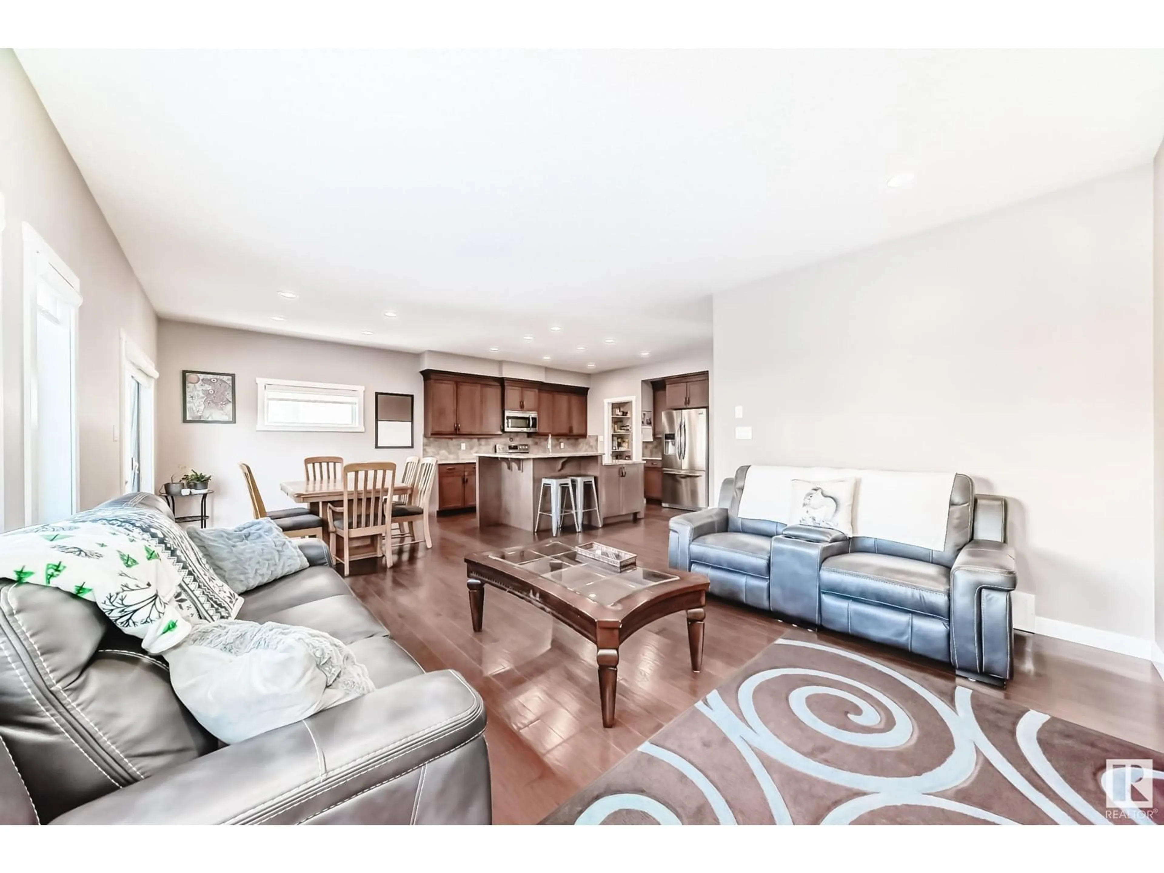 Living room with furniture, wood/laminate floor for 6042 167C AV NW, Edmonton Alberta T5Y0W7