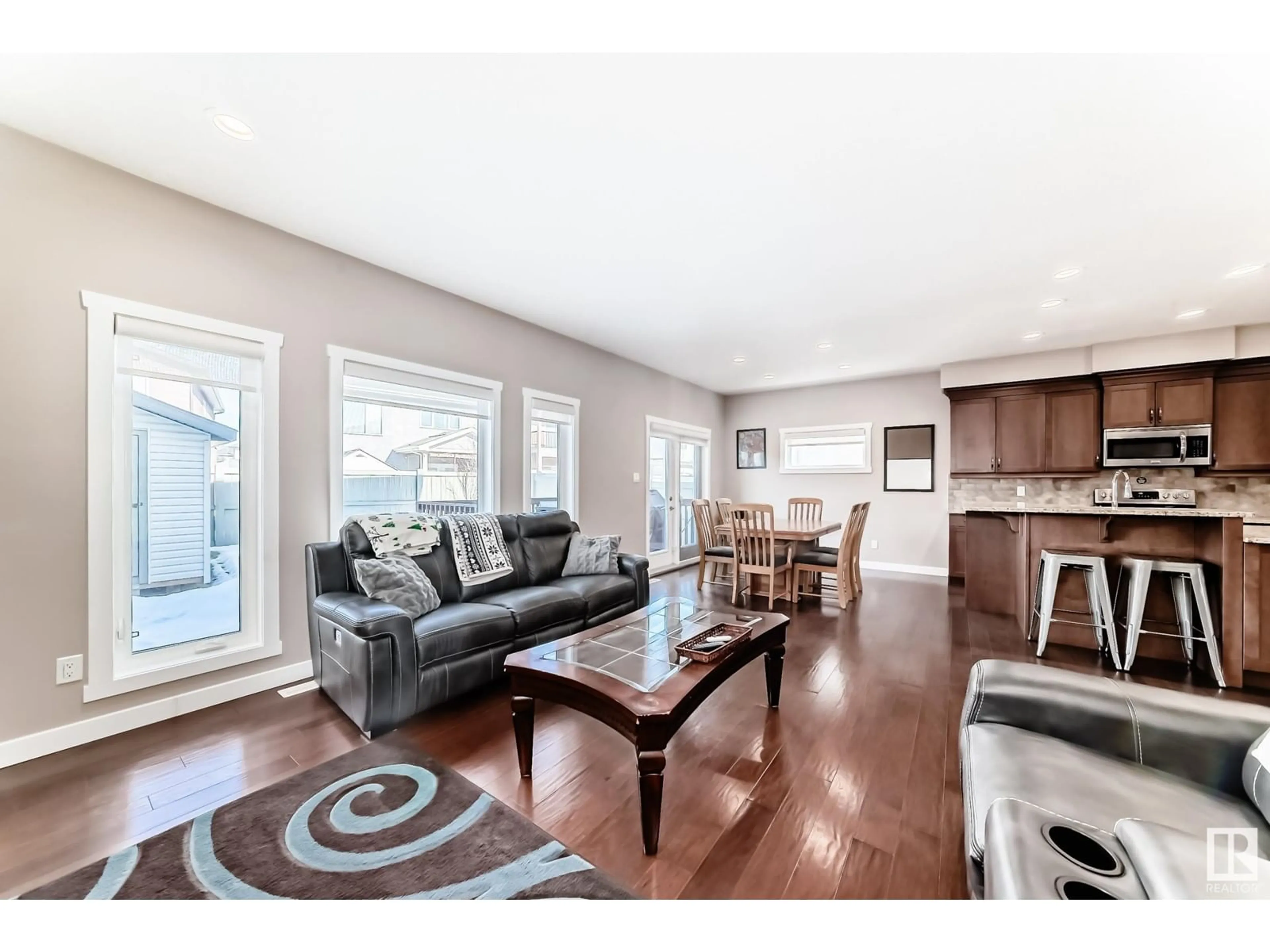 Living room with furniture, wood/laminate floor for 6042 167C AV NW, Edmonton Alberta T5Y0W7