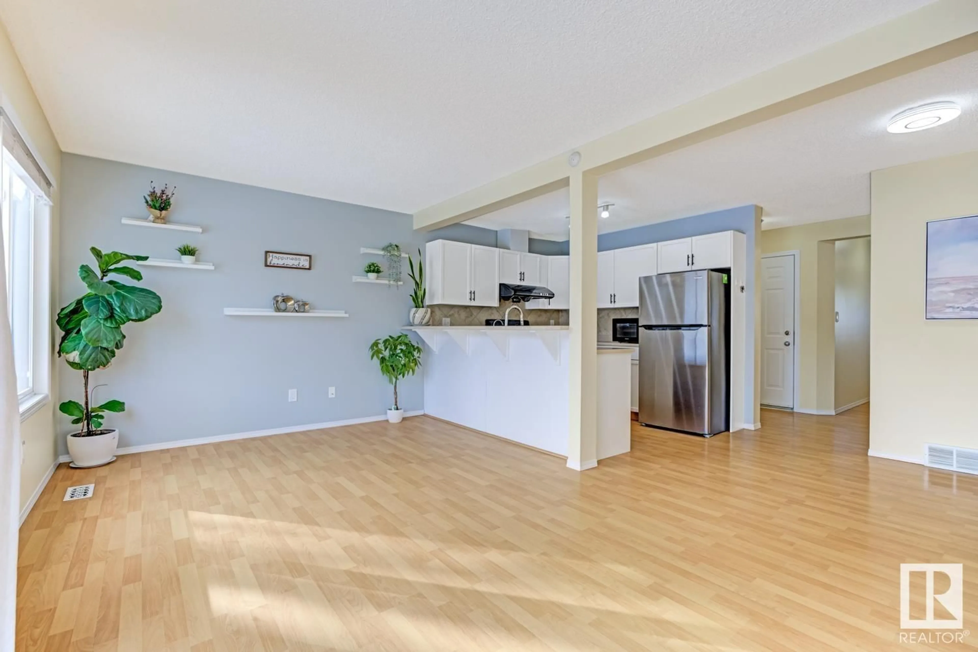 Open concept kitchen, wood/laminate floor for 16325 55A ST NW, Edmonton Alberta T5Y3L2