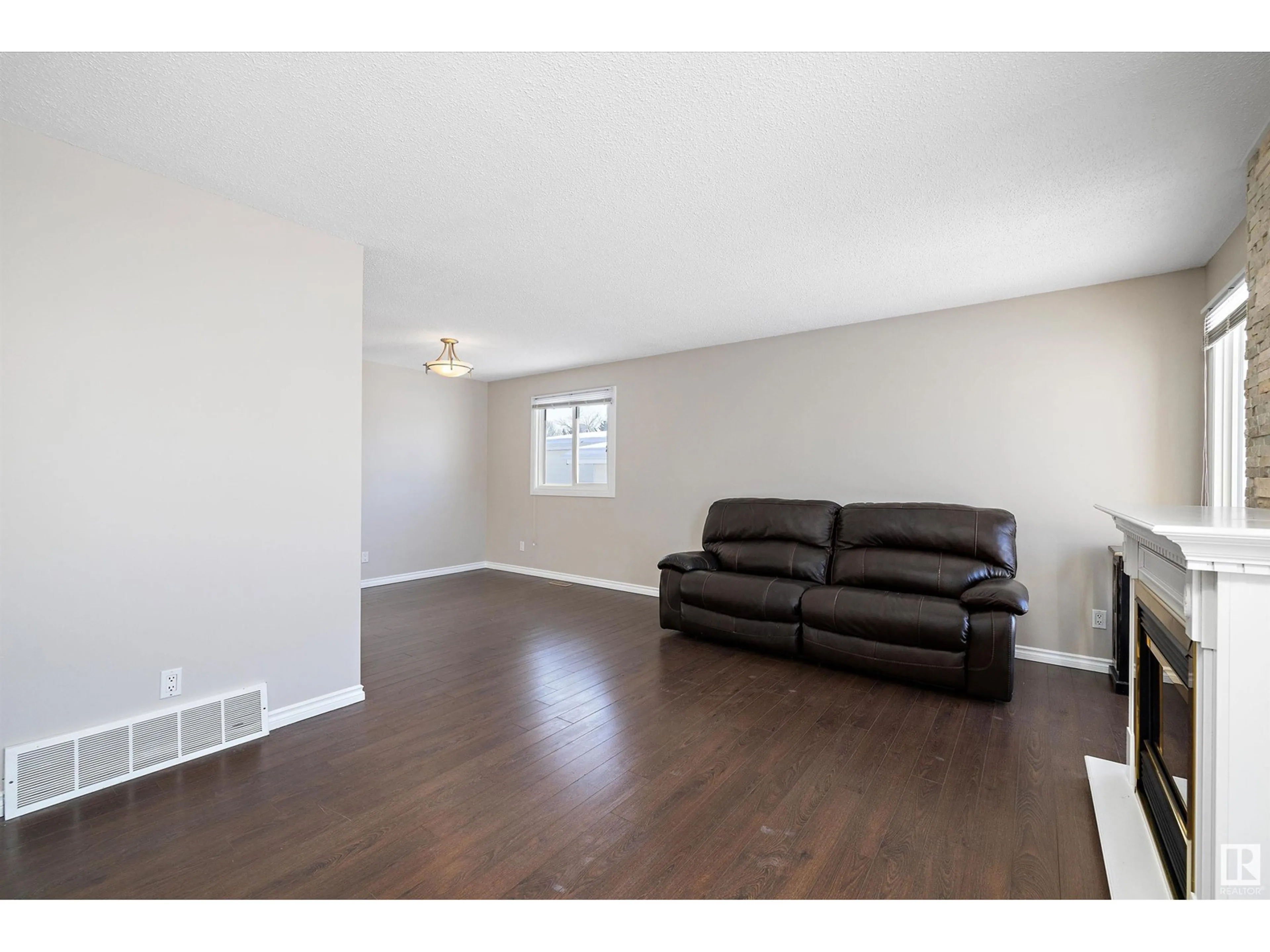 Living room with furniture, wood/laminate floor for 14923 123 ST NW, Edmonton Alberta T5X2C8