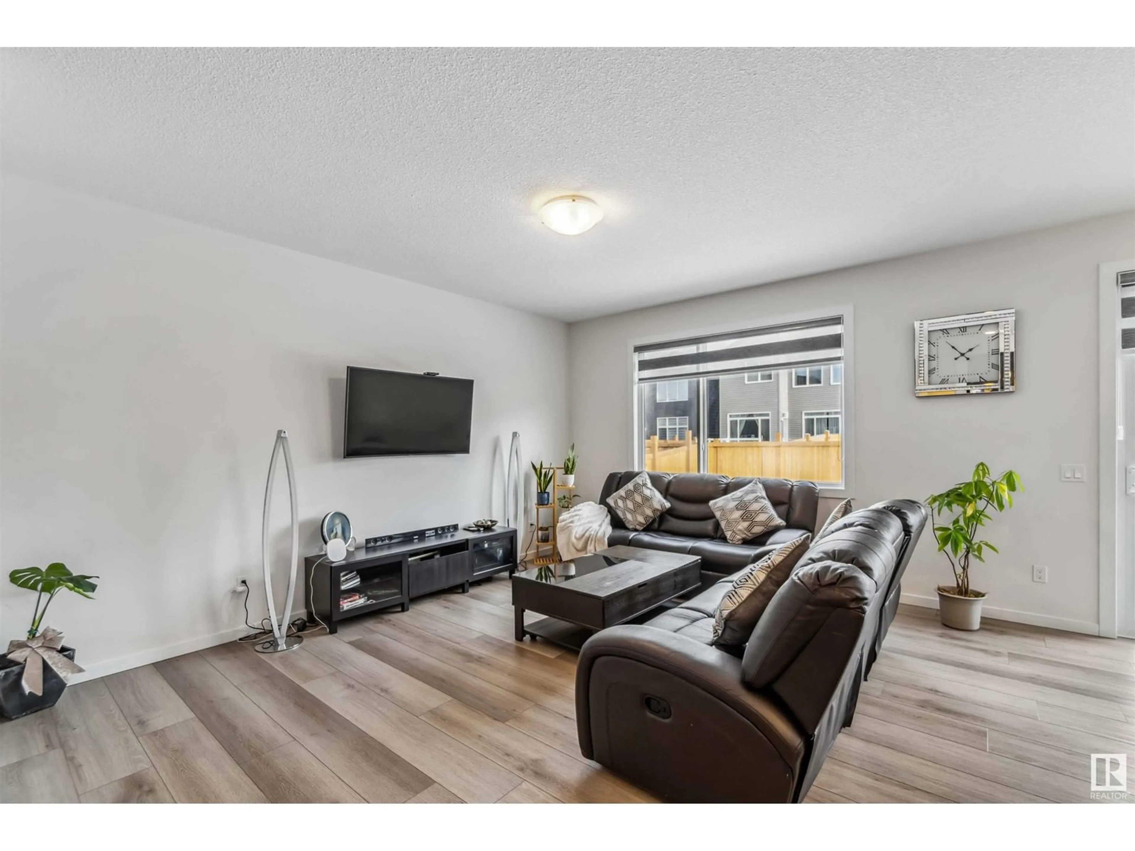 Living room with furniture, wood/laminate floor for 4335 Hawthorn Landing SW, Edmonton Alberta T6X2Y9