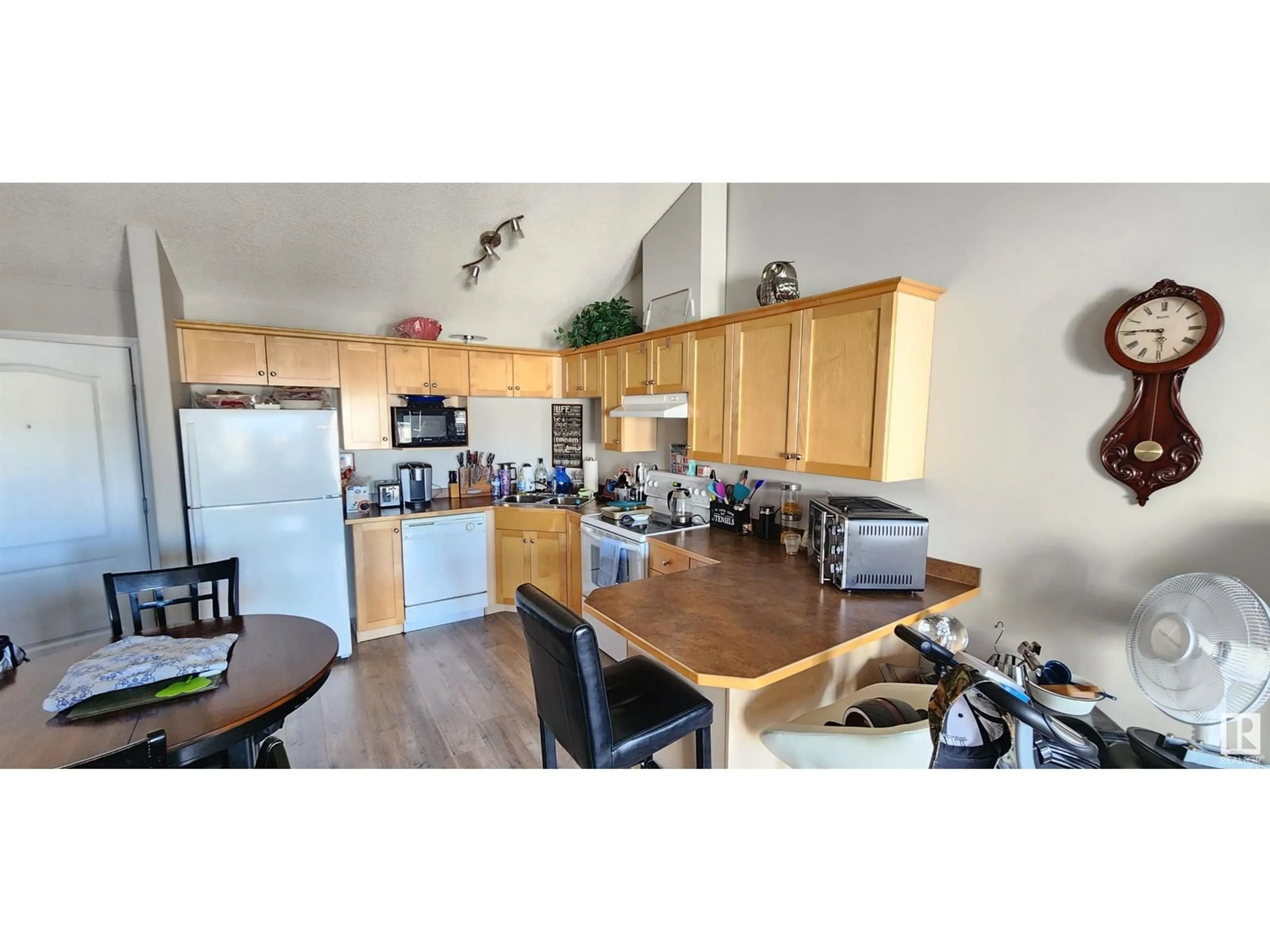 Open concept kitchen, wood/laminate floor for #428 5340 199 ST NW, Edmonton Alberta T6M0A5