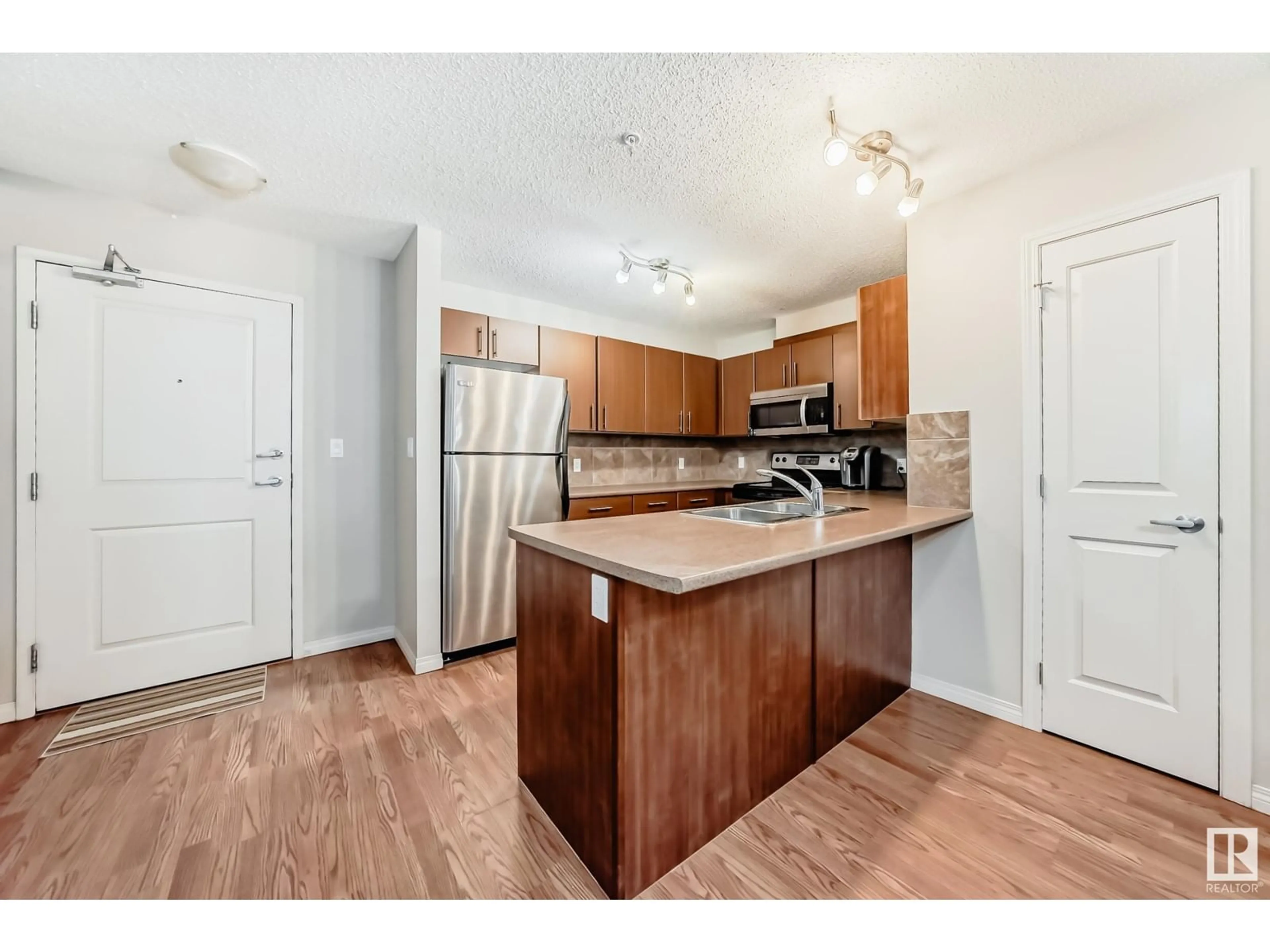 Standard kitchen, wood/laminate floor for #213 105 AMBLESIDE DR SW, Edmonton Alberta T6W0J4