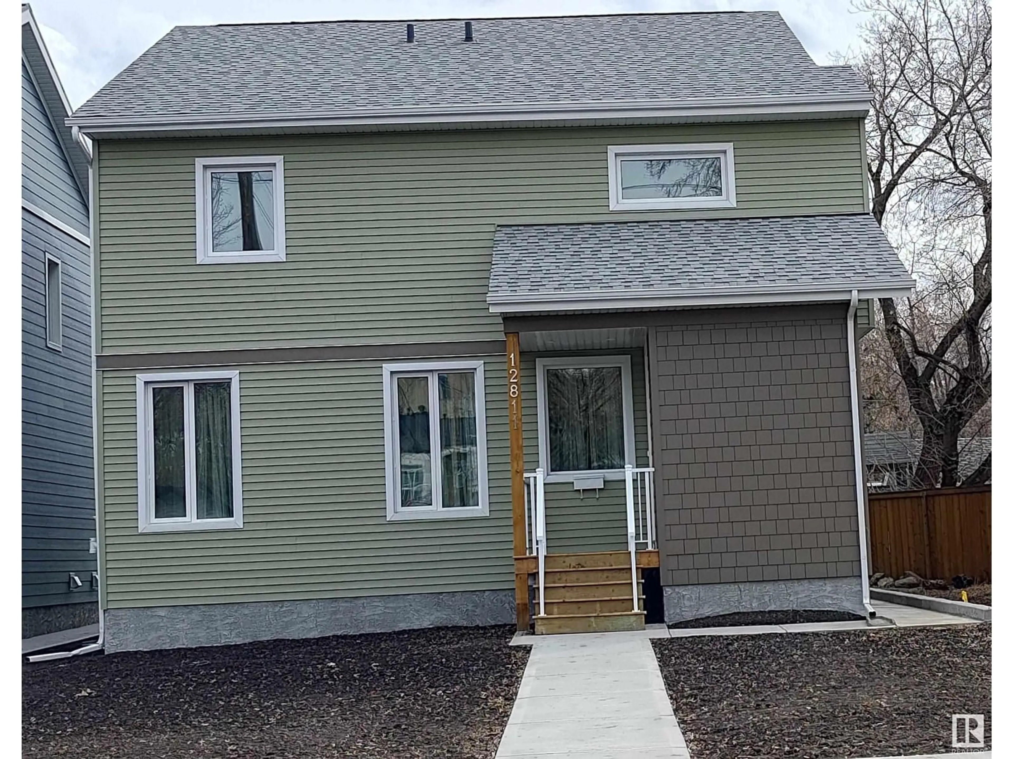 Home with vinyl exterior material, street for 12811 113 AV, Edmonton Alberta T5M2W6