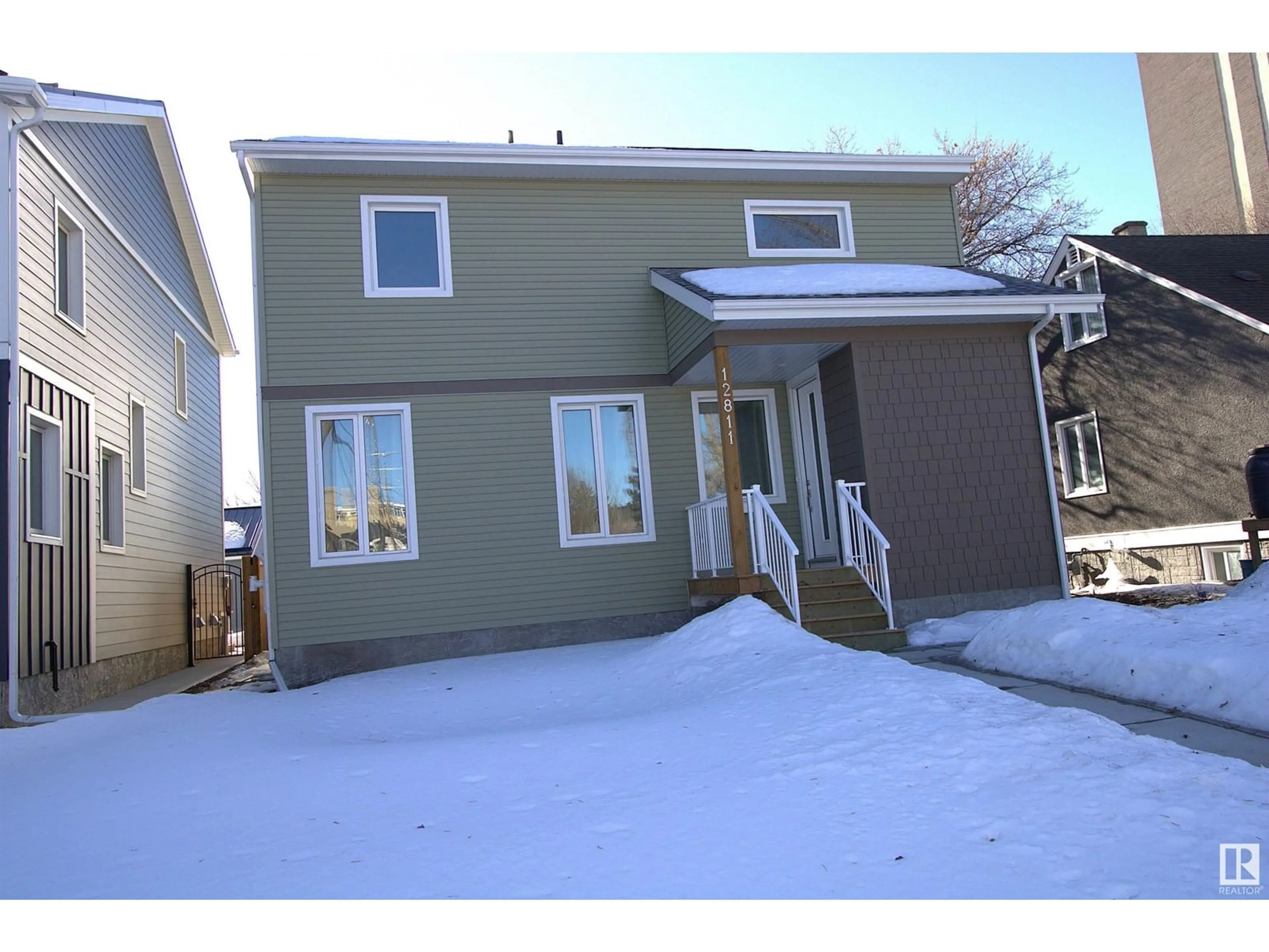 Home with vinyl exterior material, street for 12811 113 AV NW, Edmonton Alberta T5M2W6