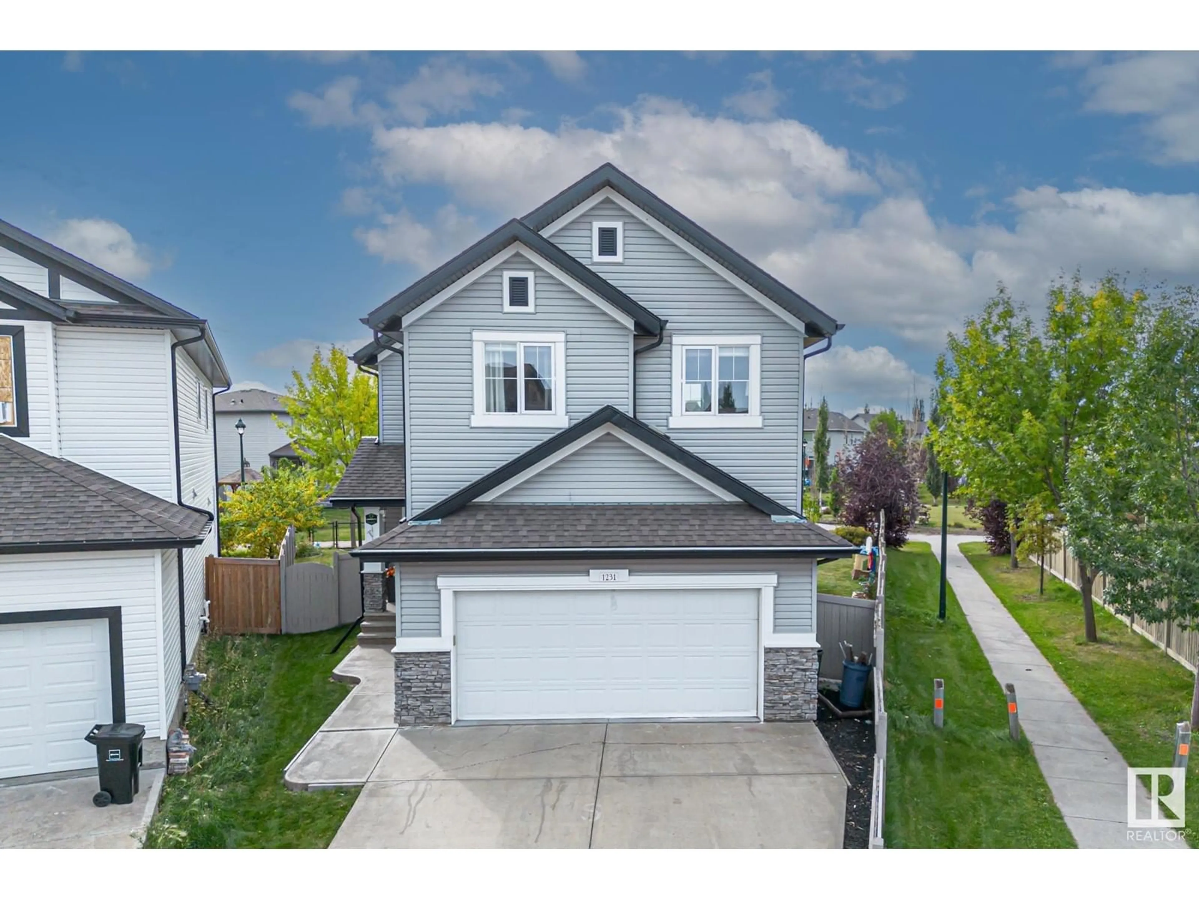 Home with vinyl exterior material, street for 1231 37A AV NW, Edmonton Alberta T6T0G3