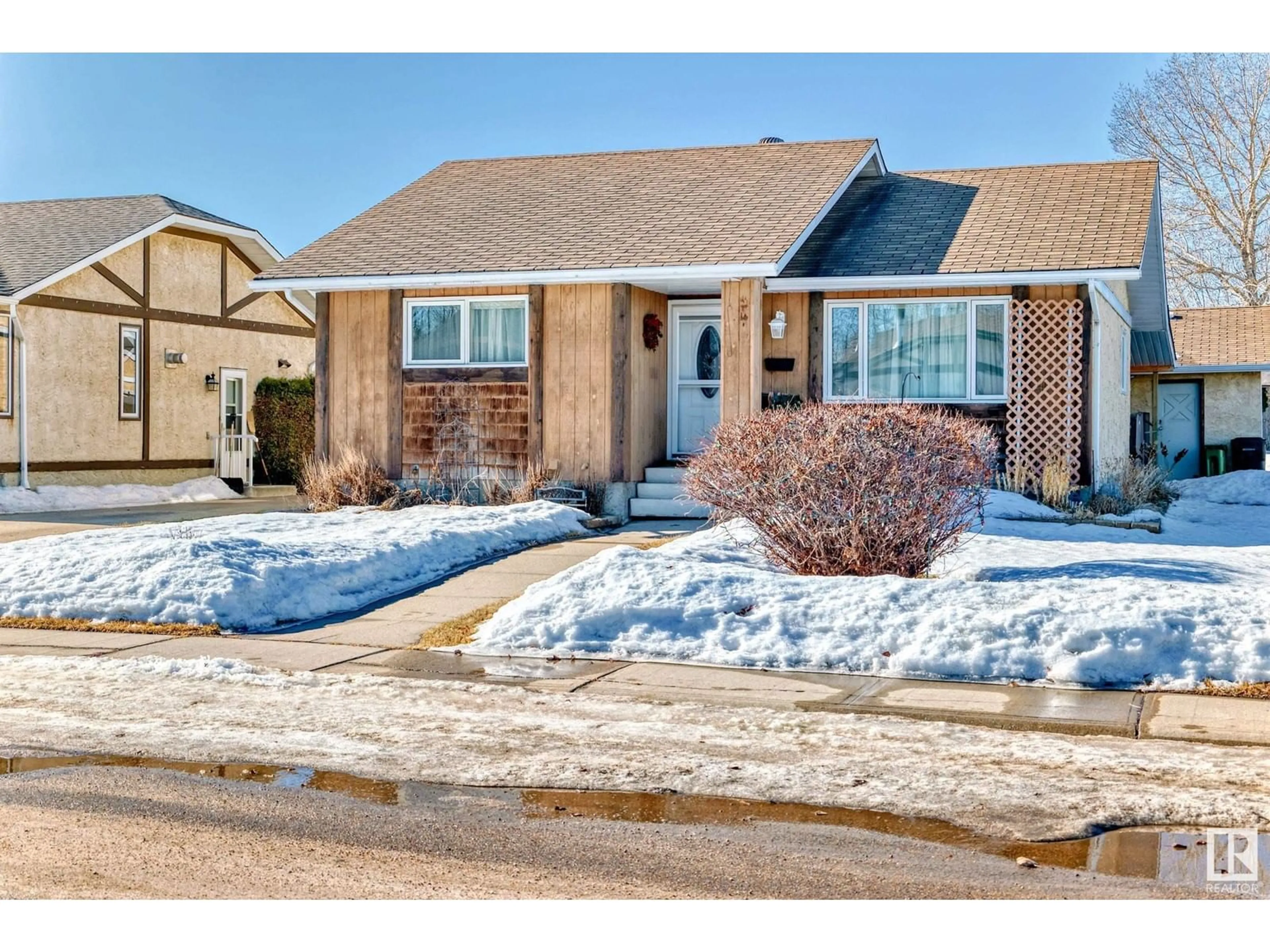 Home with brick exterior material, street for 1947 151 AV NW, Edmonton Alberta T5Y1W1