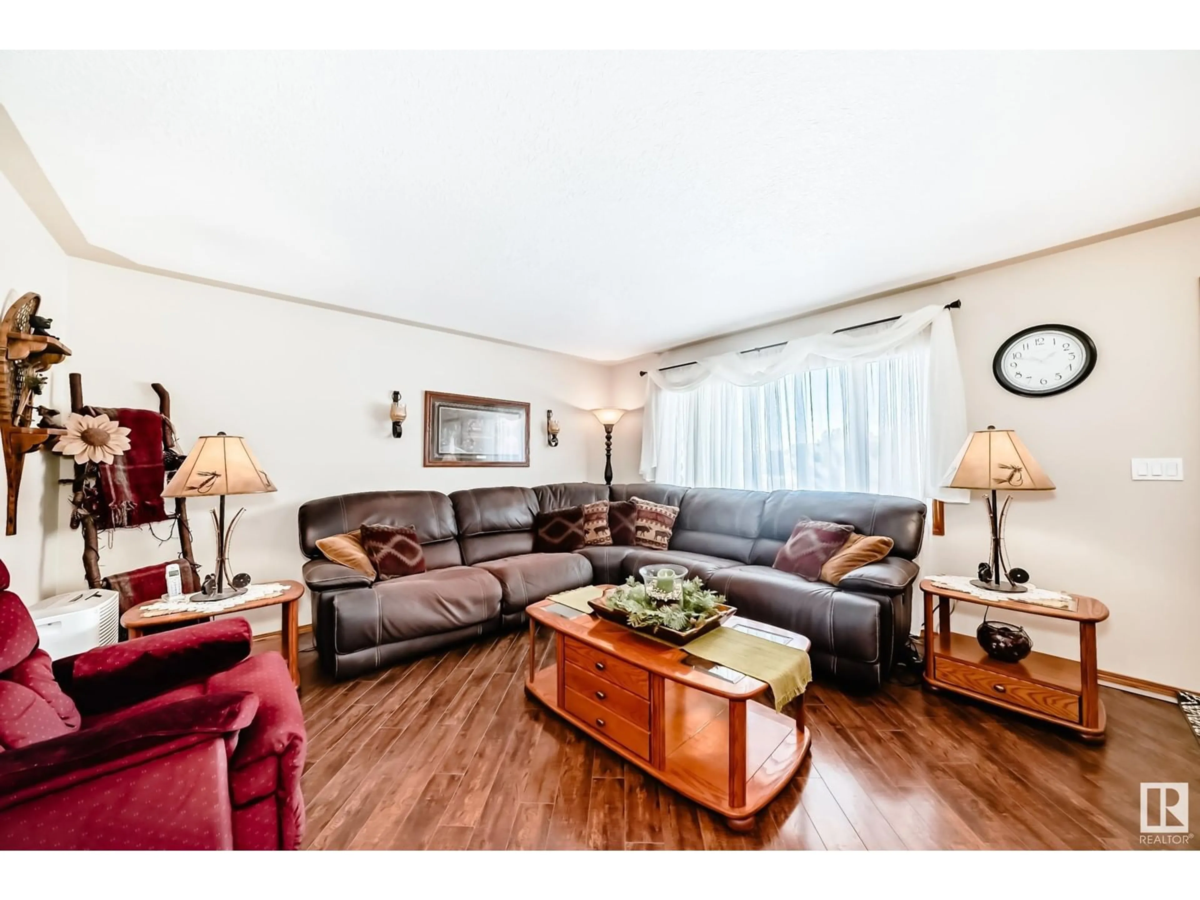 Living room with furniture, wood/laminate floor for 1947 151 AV NW, Edmonton Alberta T5Y1W1