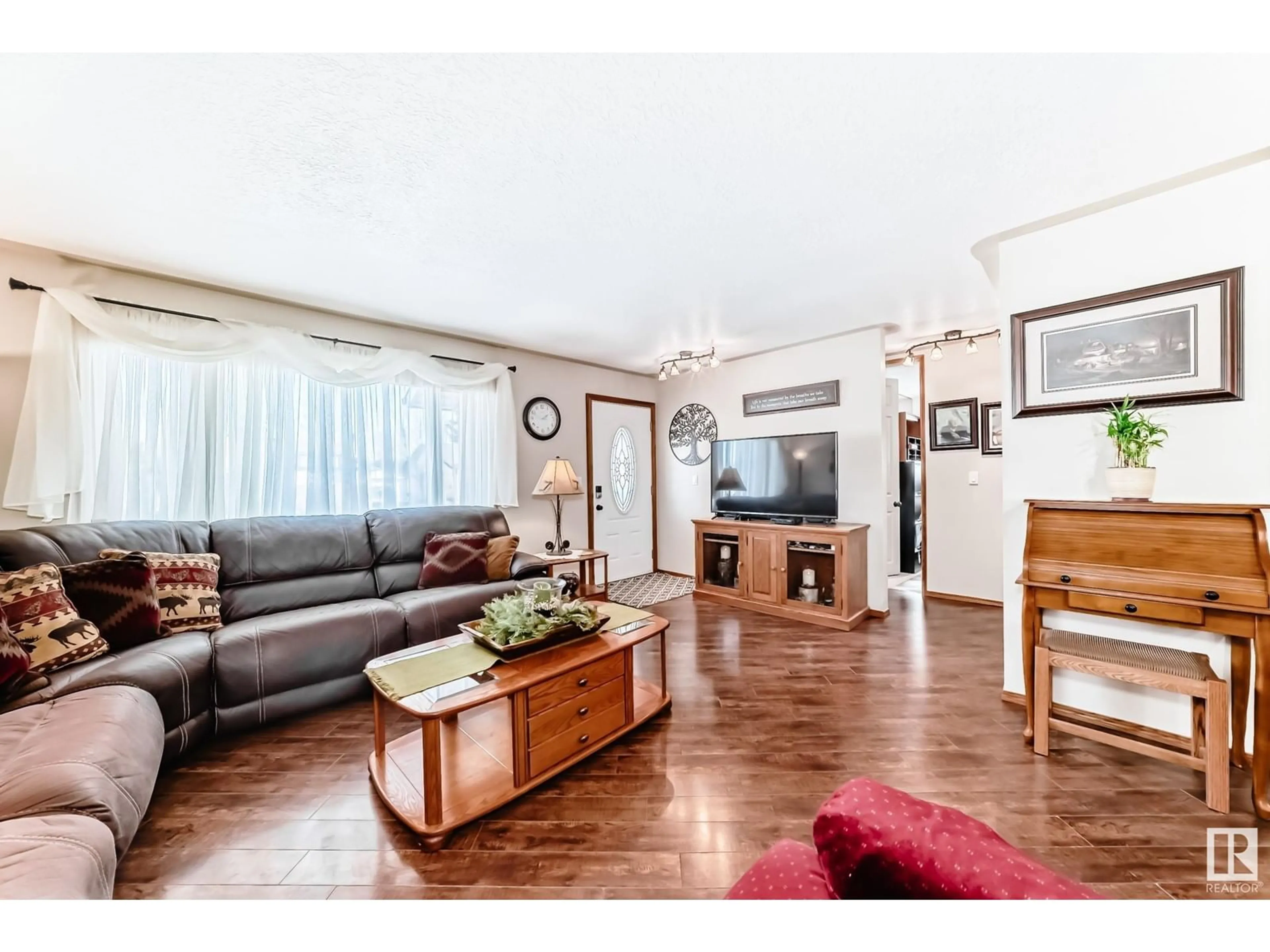 Living room with furniture, wood/laminate floor for 1947 151 AV NW, Edmonton Alberta T5Y1W1