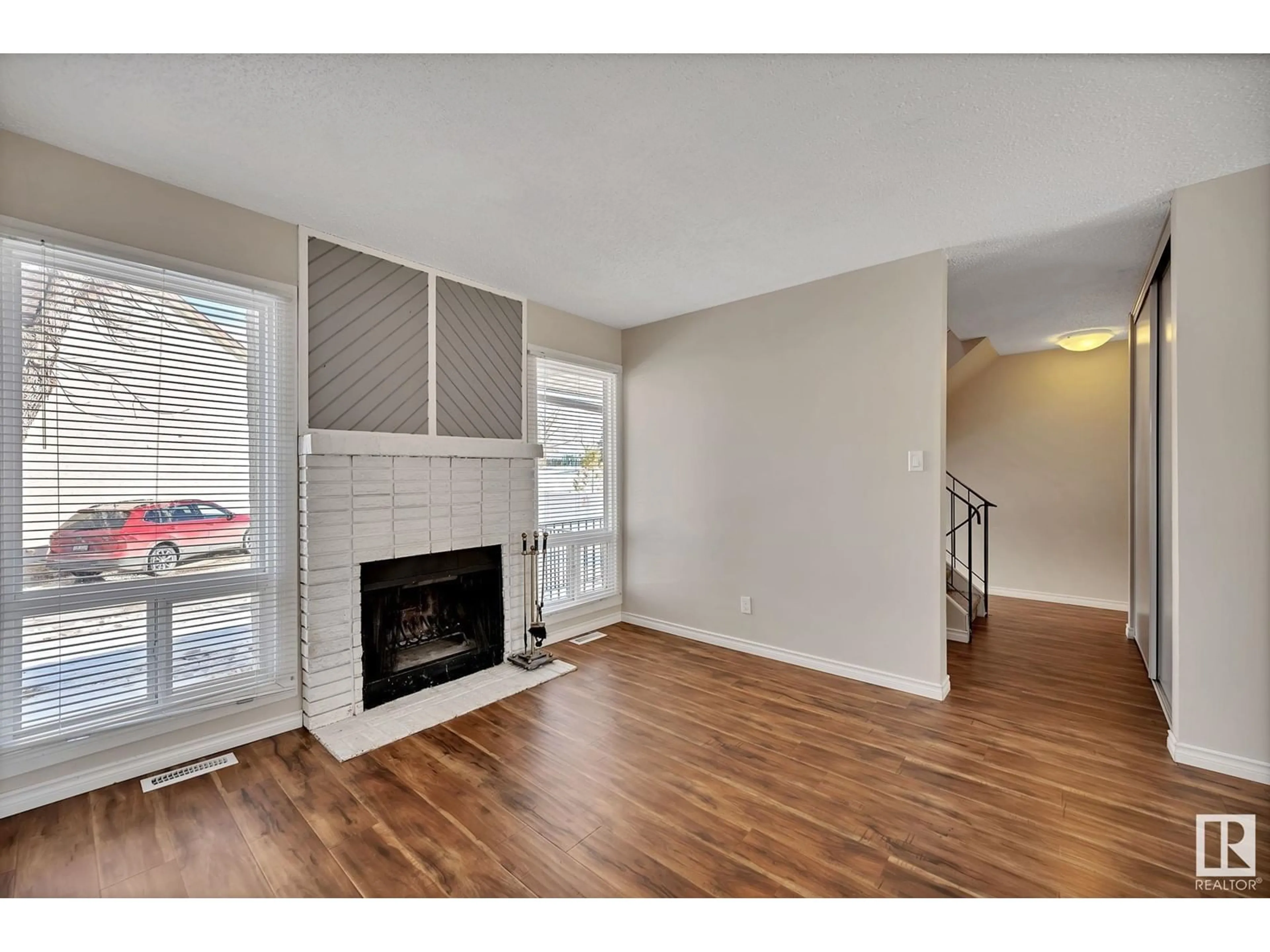 Living room with furniture, wood/laminate floor for 1113 62 ST NW, Edmonton Alberta T6L2H7