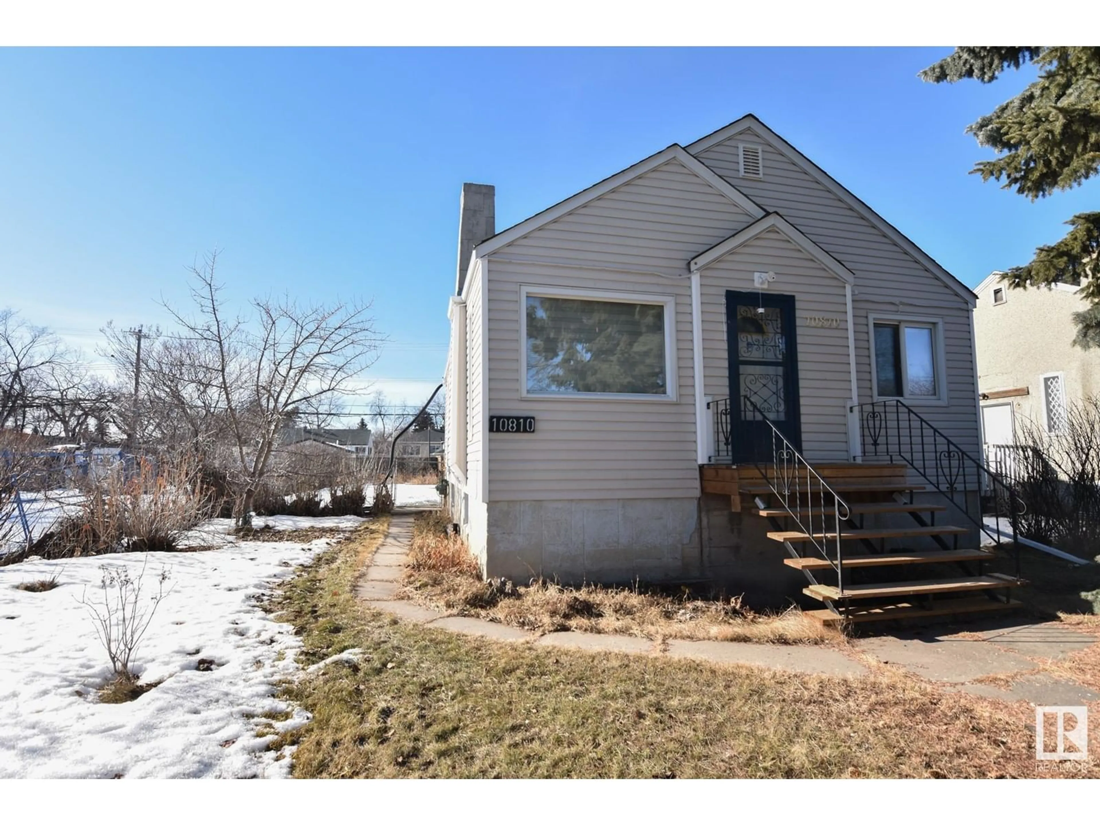 Home with vinyl exterior material, street for 10810 106 ST NW, Edmonton Alberta T5H2Y2