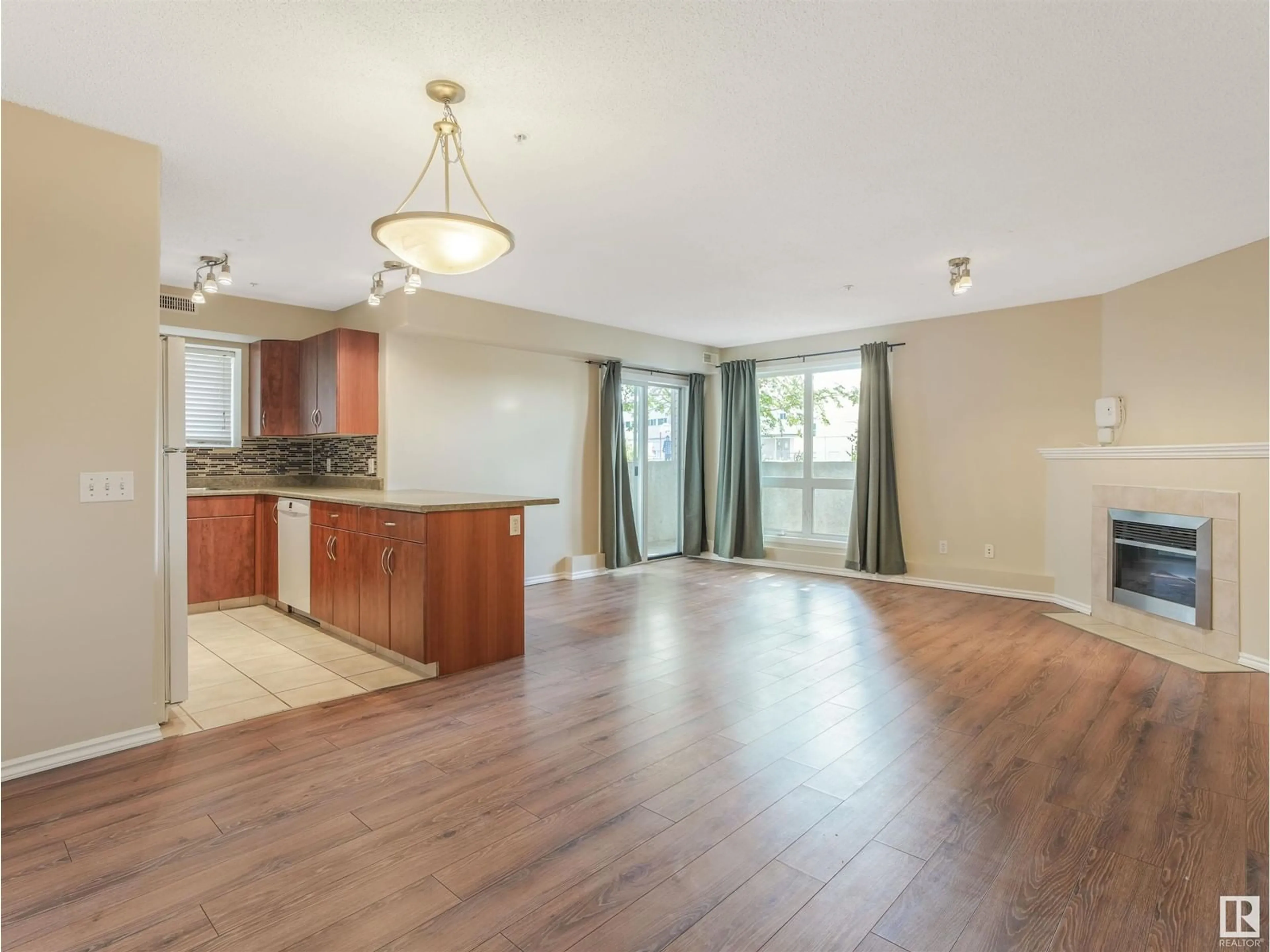 Open concept kitchen, wood/laminate floor for #101 10528 77 AV NW, Edmonton Alberta T6E1N1