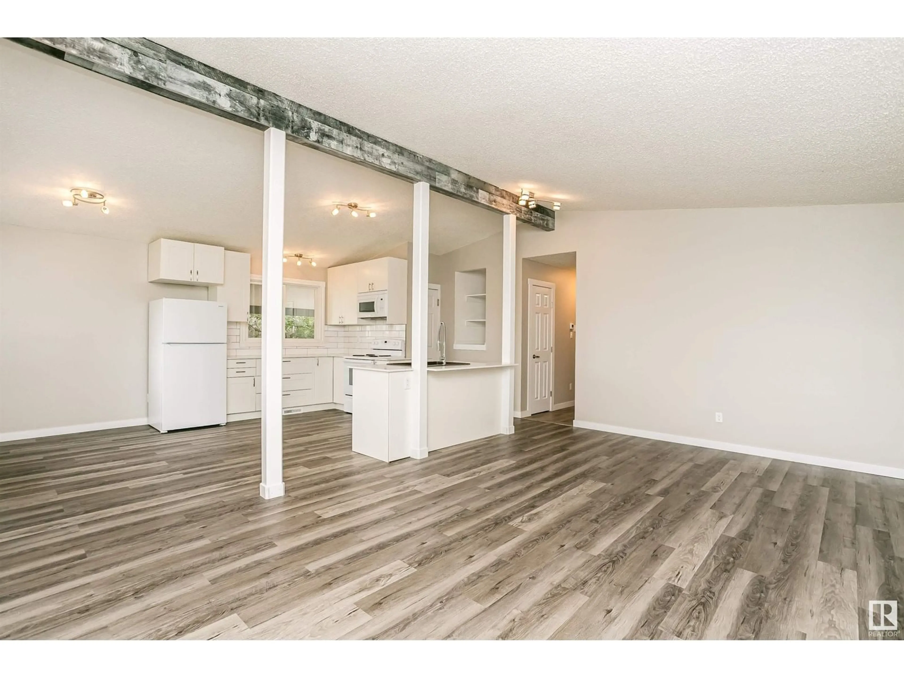 Open concept kitchen, wood/laminate floor for 13412 94 ST NW, Edmonton Alberta T5E3V9