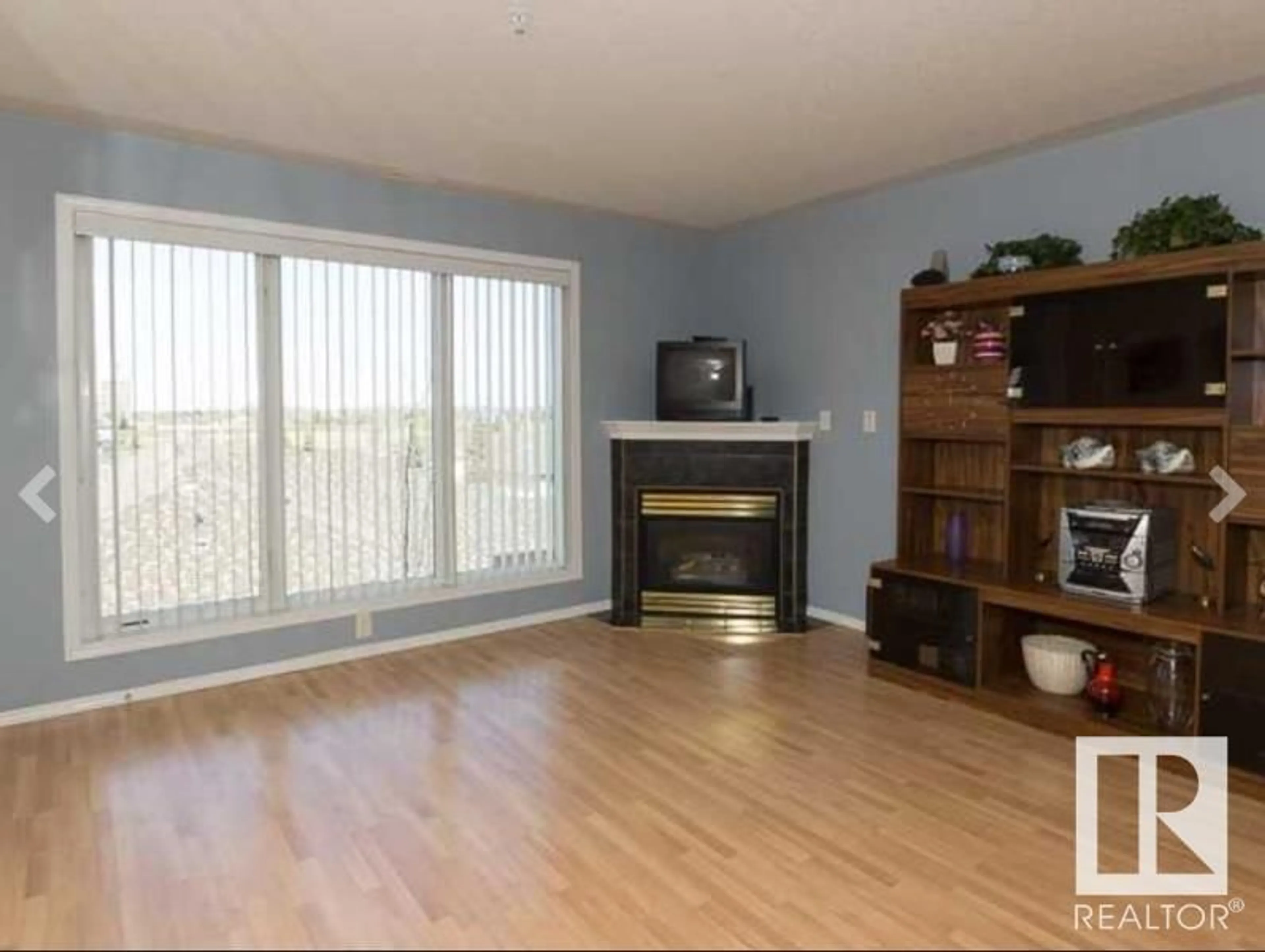 Living room with furniture, wood/laminate floor for #308 237 YOUVILLE DR NW, Edmonton Alberta T6L7G2