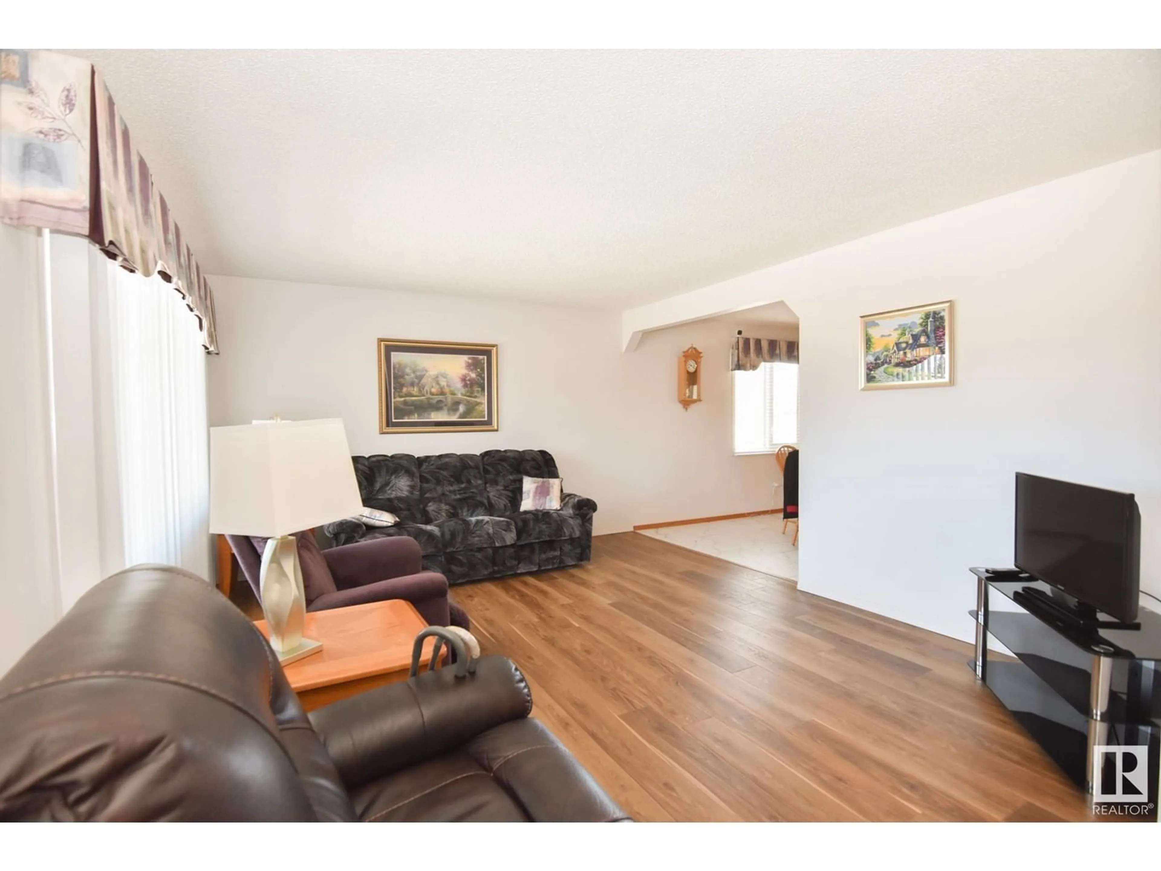 Living room with furniture, wood/laminate floor for 15015 72 ST NW, Edmonton Alberta T5C0S1