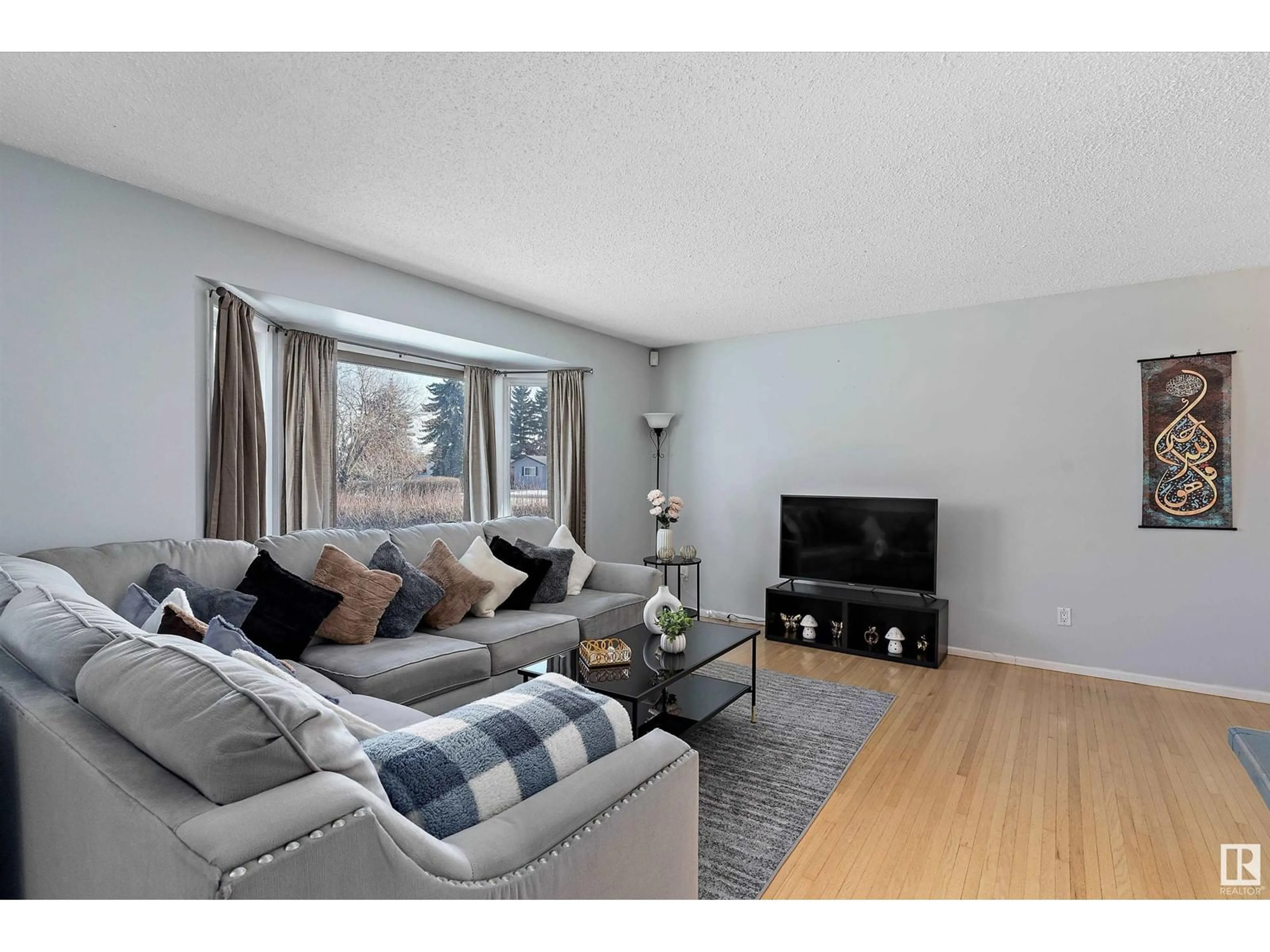 Living room with furniture, wood/laminate floor for 13216 67 ST NW, Edmonton Alberta T5C0C4