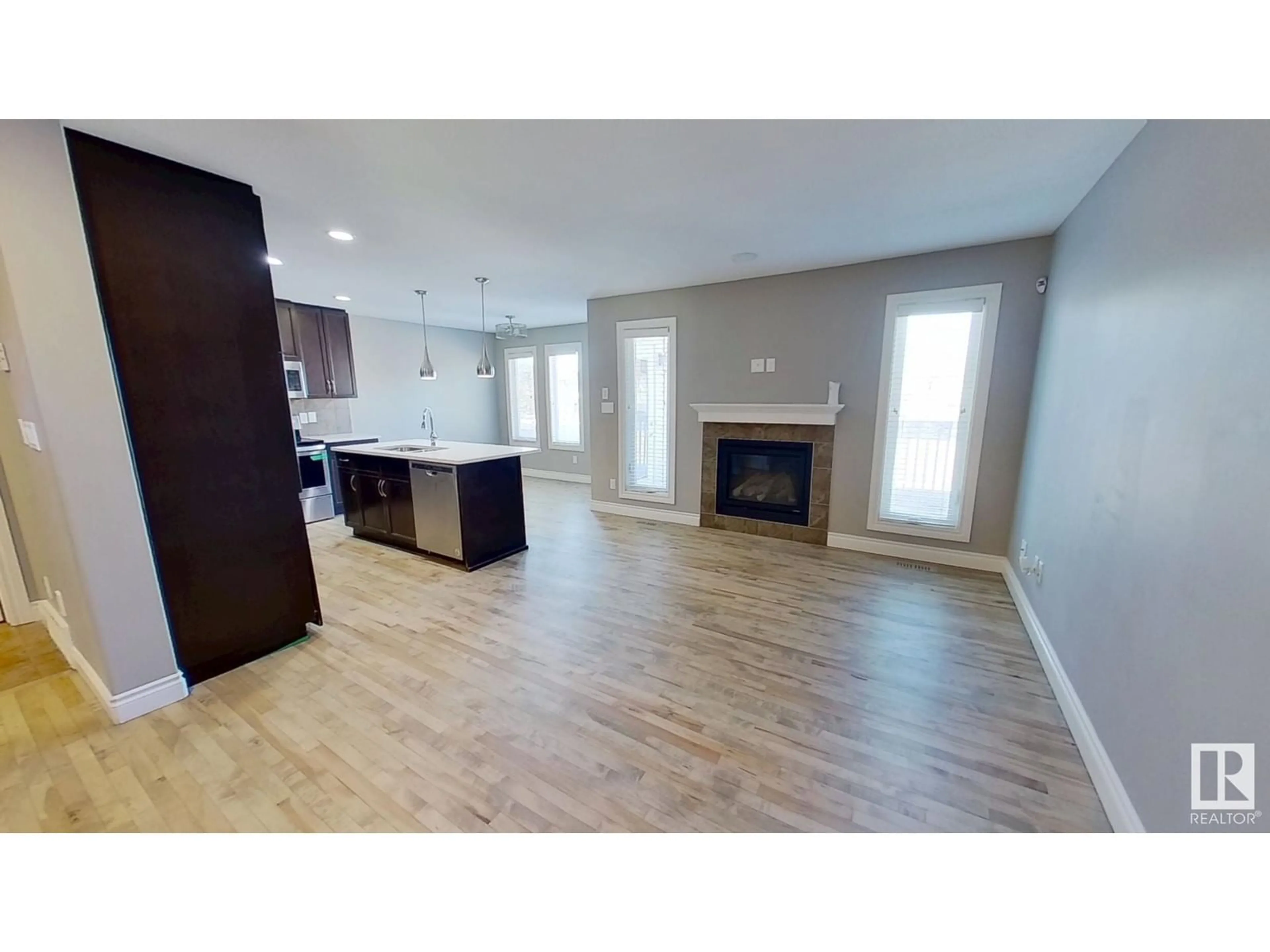 Open concept kitchen, wood/laminate floor for 2046 69A ST SW, Edmonton Alberta T6X0S5