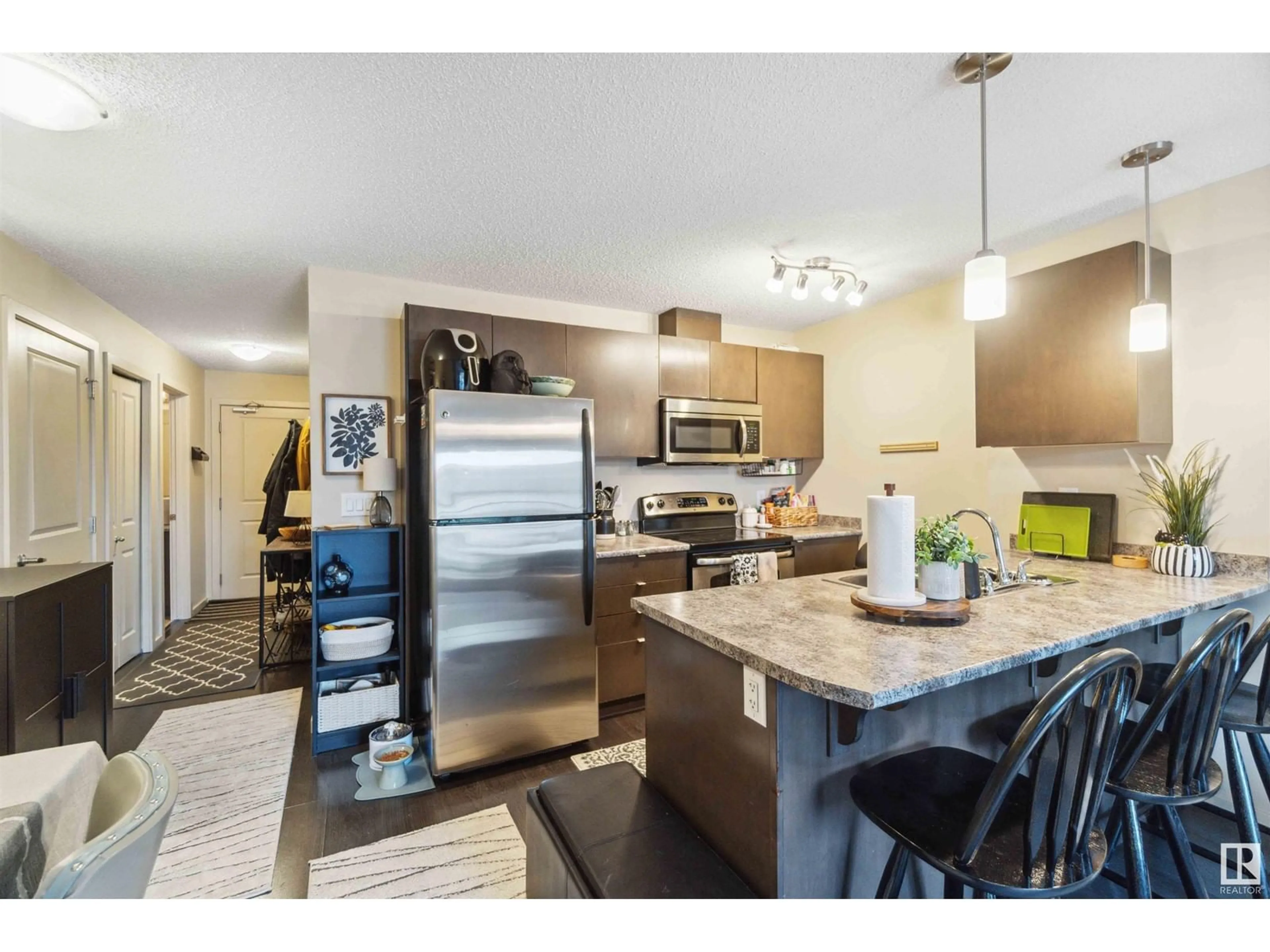 Open concept kitchen, wood/laminate floor for #409 3353 16A AV NW, Edmonton Alberta T6T0V4