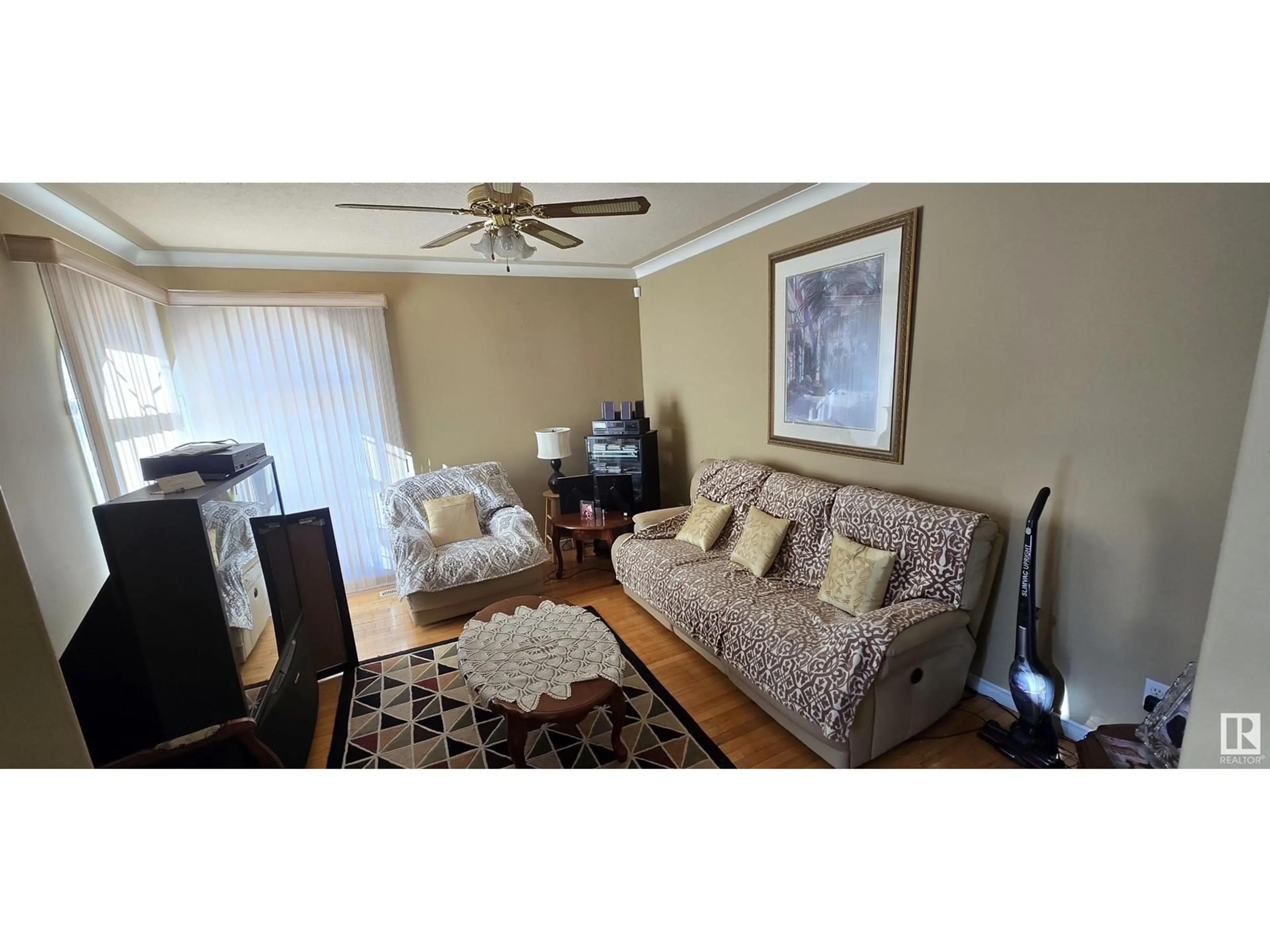 Living room with furniture, wood/laminate floor for 12223 63 ST NW, Edmonton Alberta T5W5G7