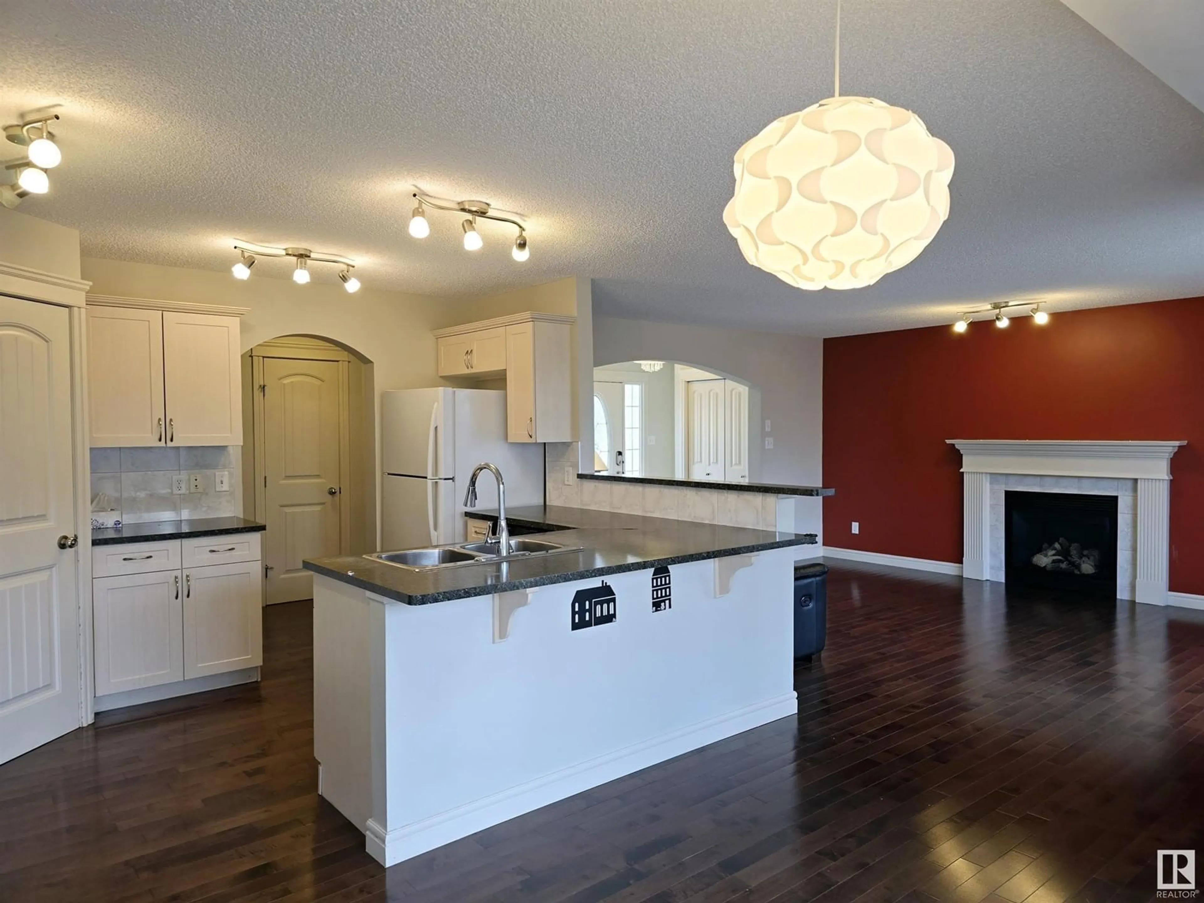 Open concept kitchen, wood/laminate floor for SW - 11808 13 AV, Edmonton Alberta T6W0C1