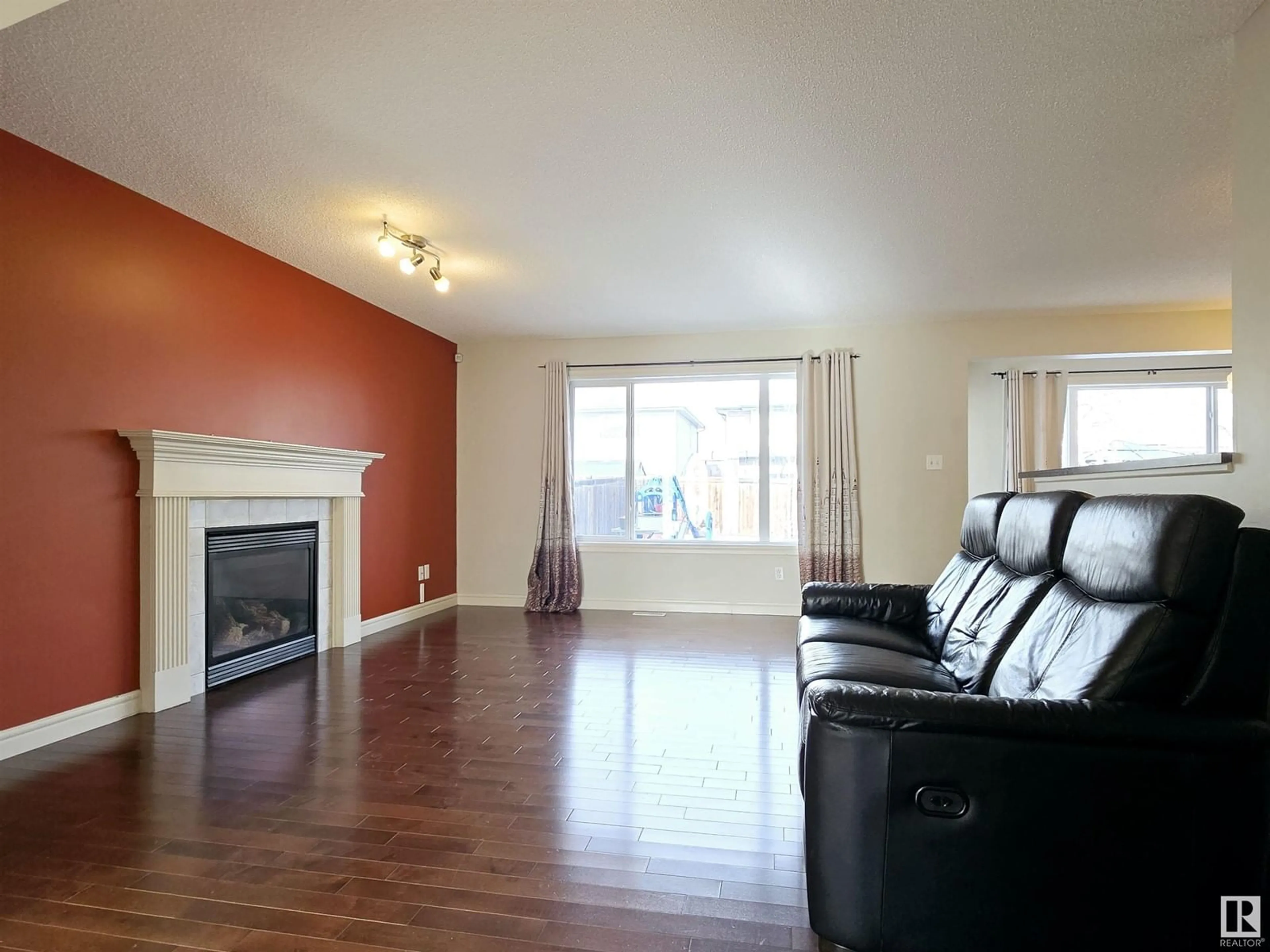 Living room with furniture, wood/laminate floor for 11808 13 AV SW, Edmonton Alberta T6W0C1