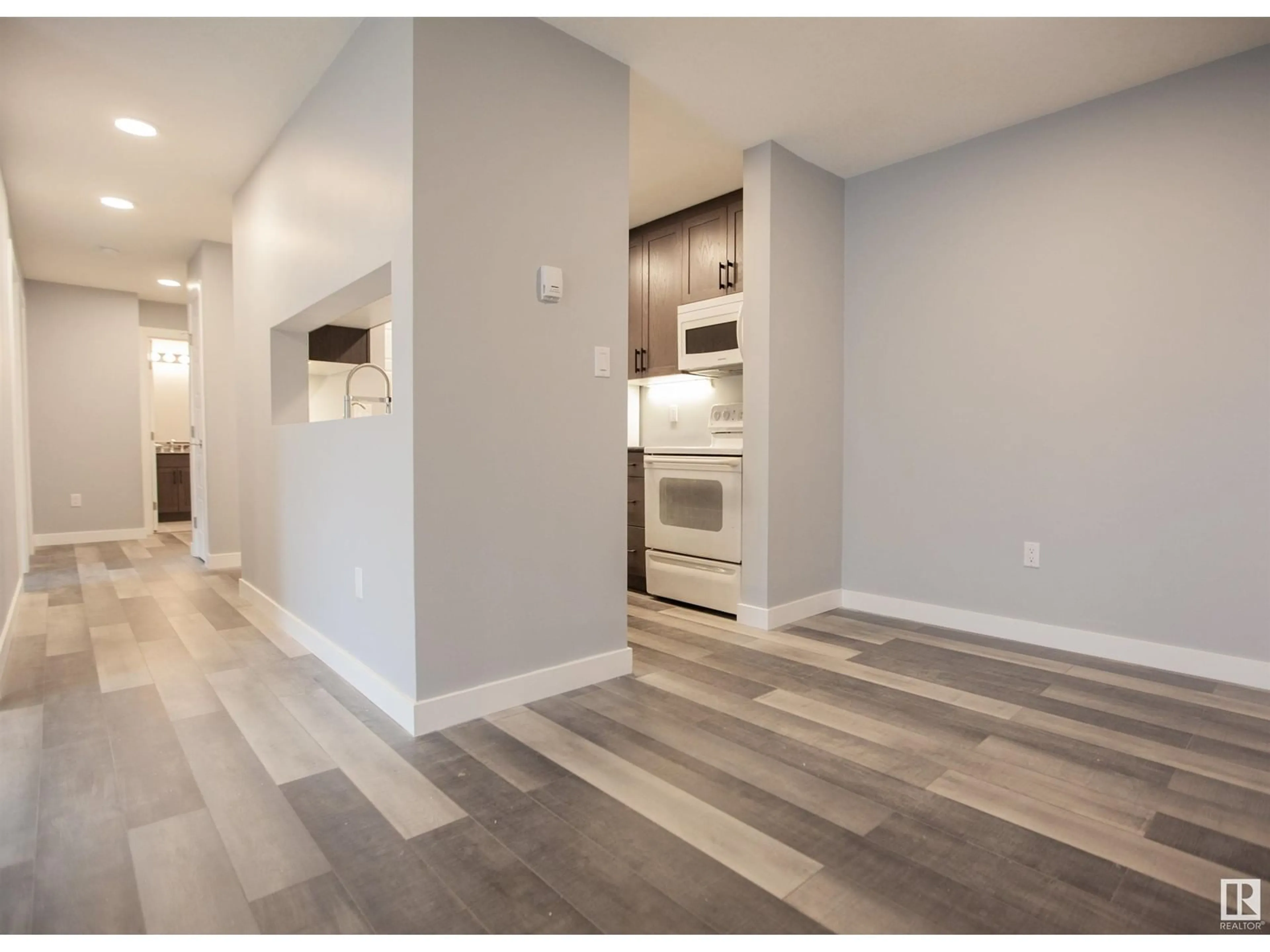 Open concept kitchen, wood/laminate floor for #109 2508 50 ST NW NW, Edmonton Alberta T6L6X9