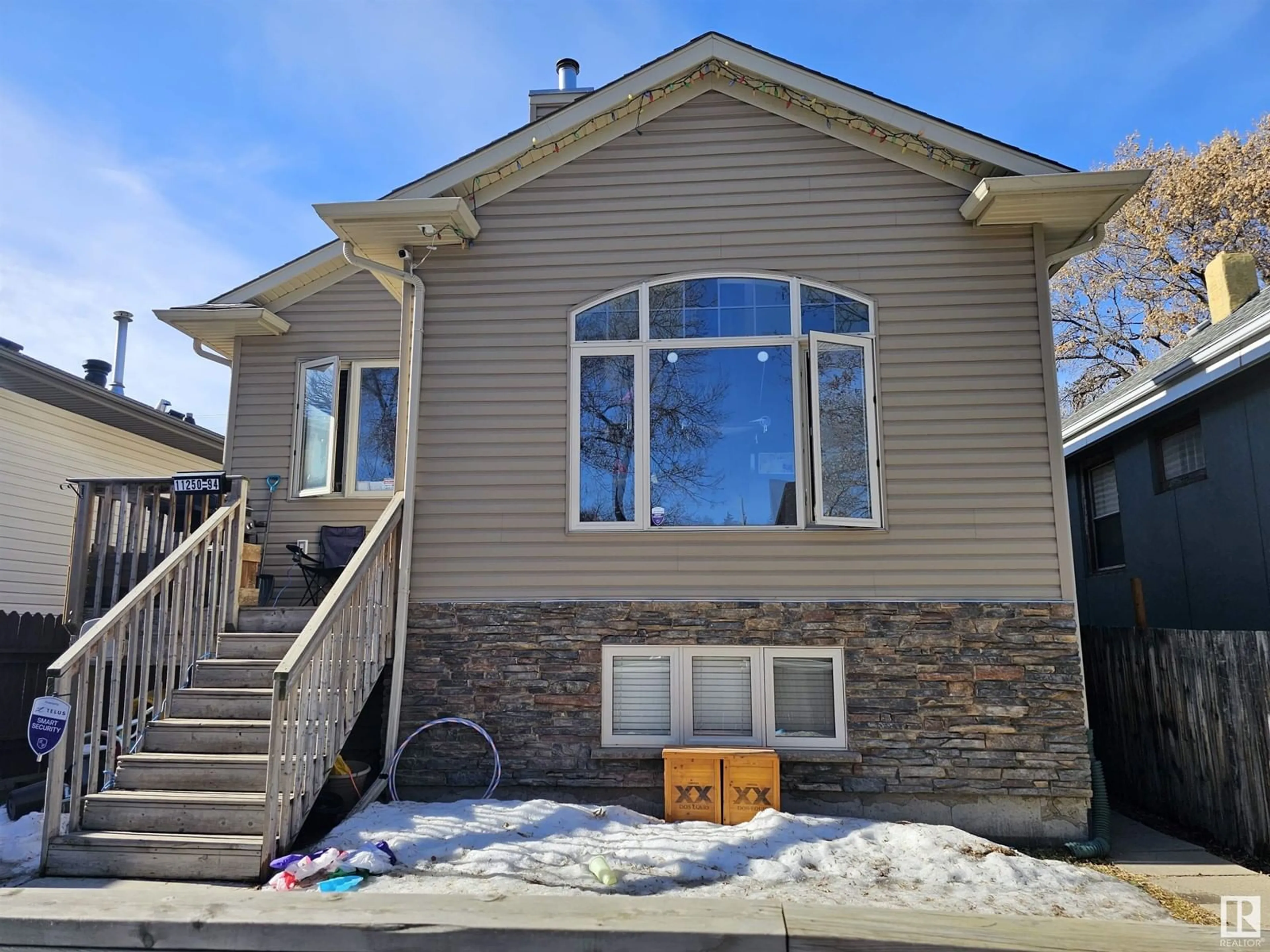 Home with vinyl exterior material, street for 11250 94st NW NW, Edmonton Alberta T5G1G9