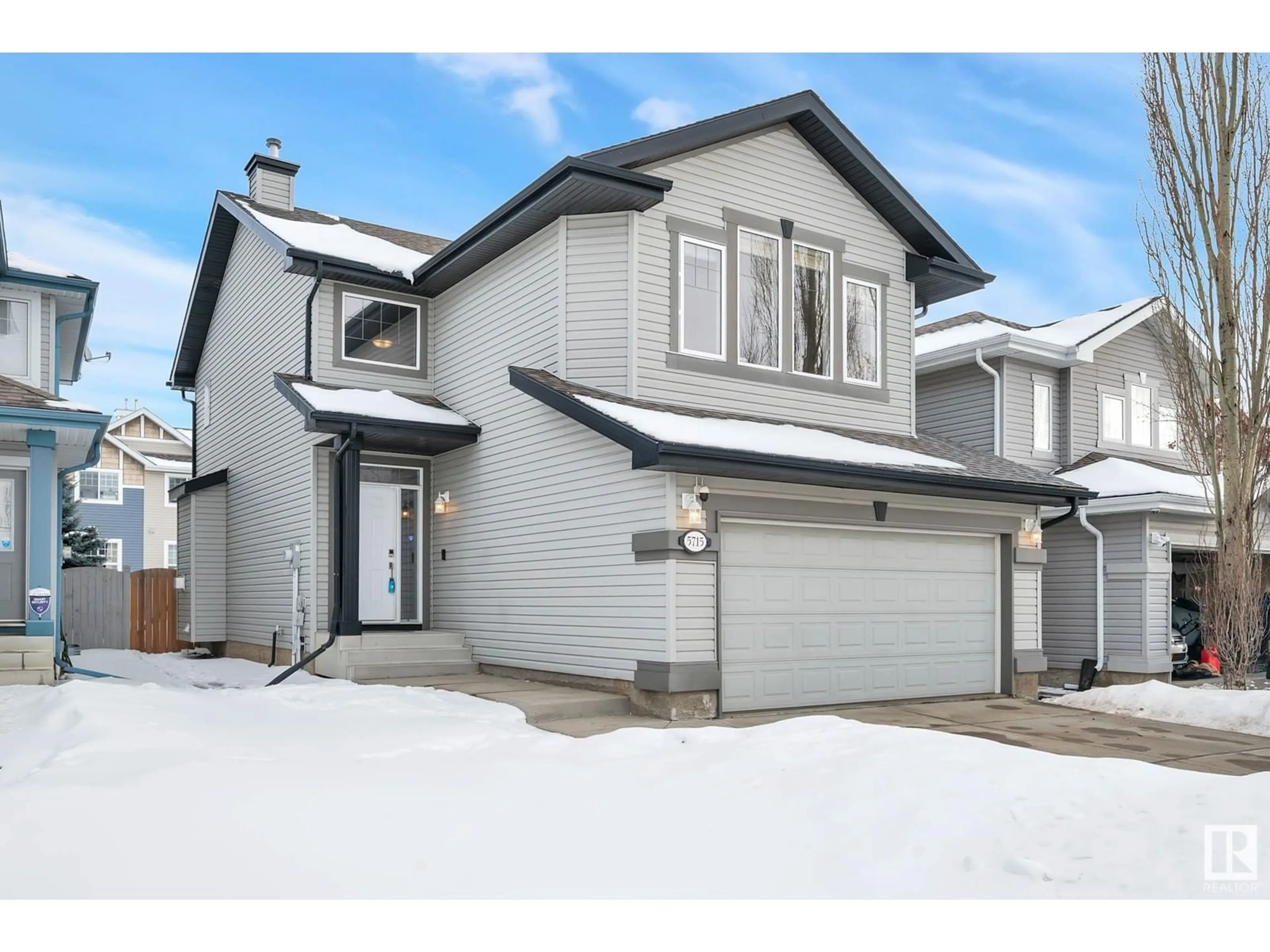 Home with vinyl exterior material, street for 5715 201 ST NW, Edmonton Alberta T6M0B4