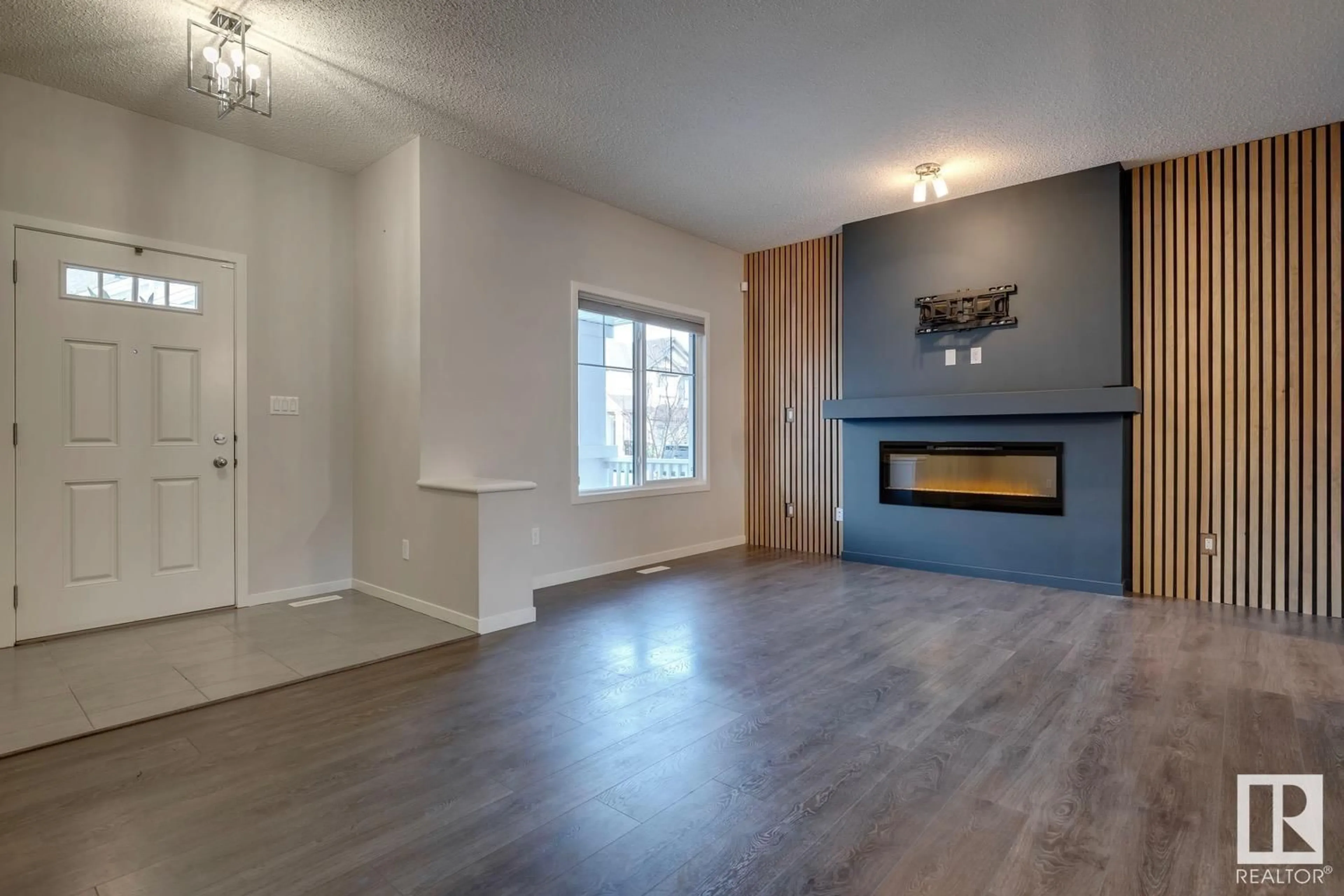 Living room with furniture, wood/laminate floor for 7782 EIFERT CR NW, Edmonton Alberta T6M0W1