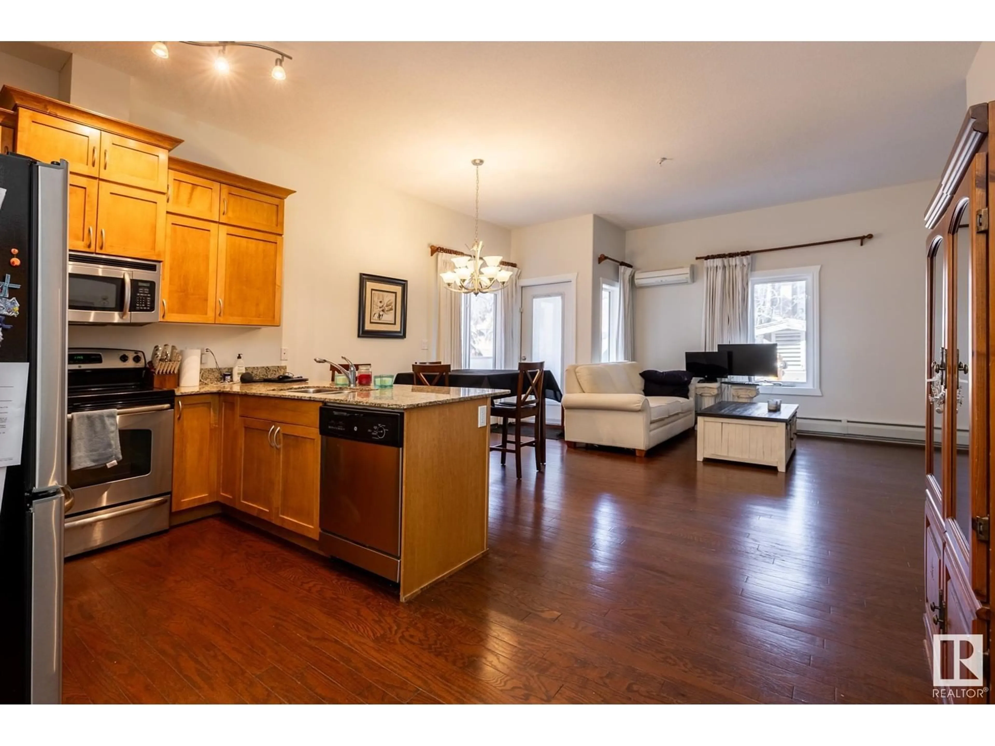 Open concept kitchen, wood/laminate floor for #101 10235 116 ST NW, Edmonton Alberta T5K1W3