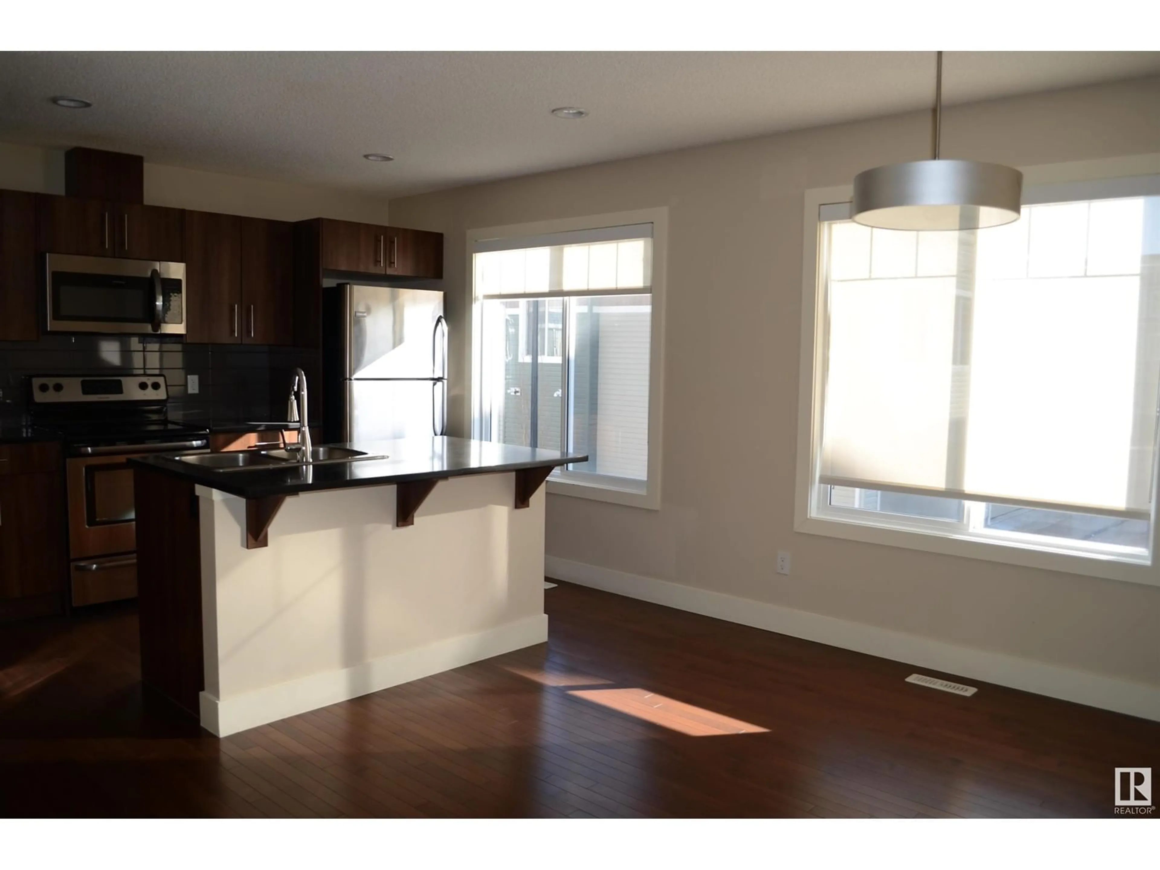 Open concept kitchen, wood/laminate floor for #36 2922 MAPLE WY NW, Edmonton Alberta T6T1A5