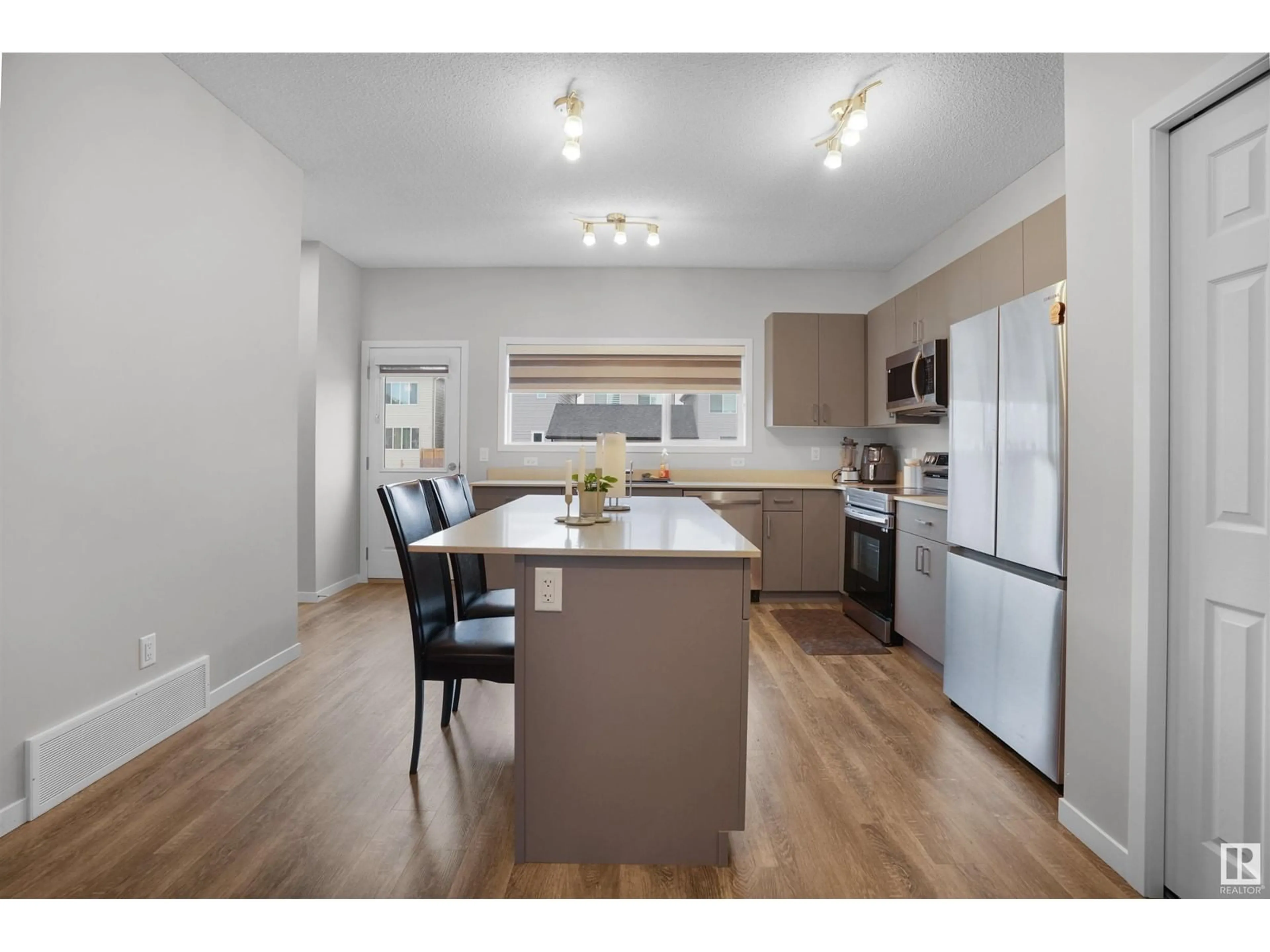 Open concept kitchen, wood/laminate floor for 1304 16 ST NW, Edmonton Alberta T6T1J1