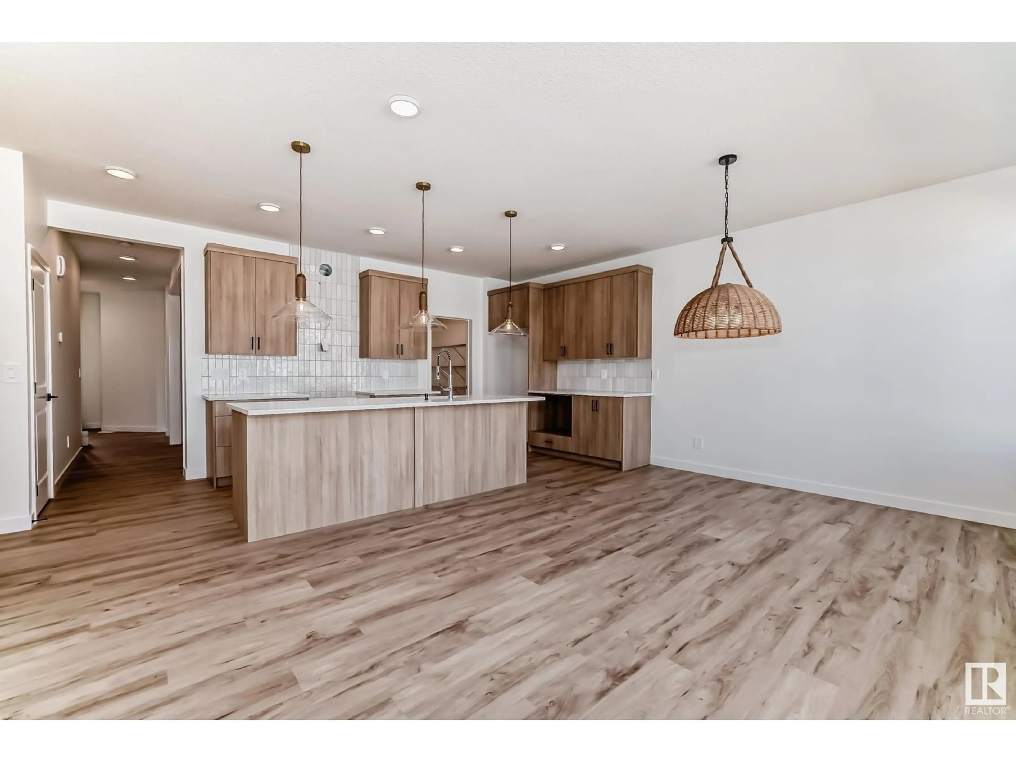 Open concept kitchen, wood/laminate floor for 16735 34 AV SW, Edmonton Alberta T6W5M2