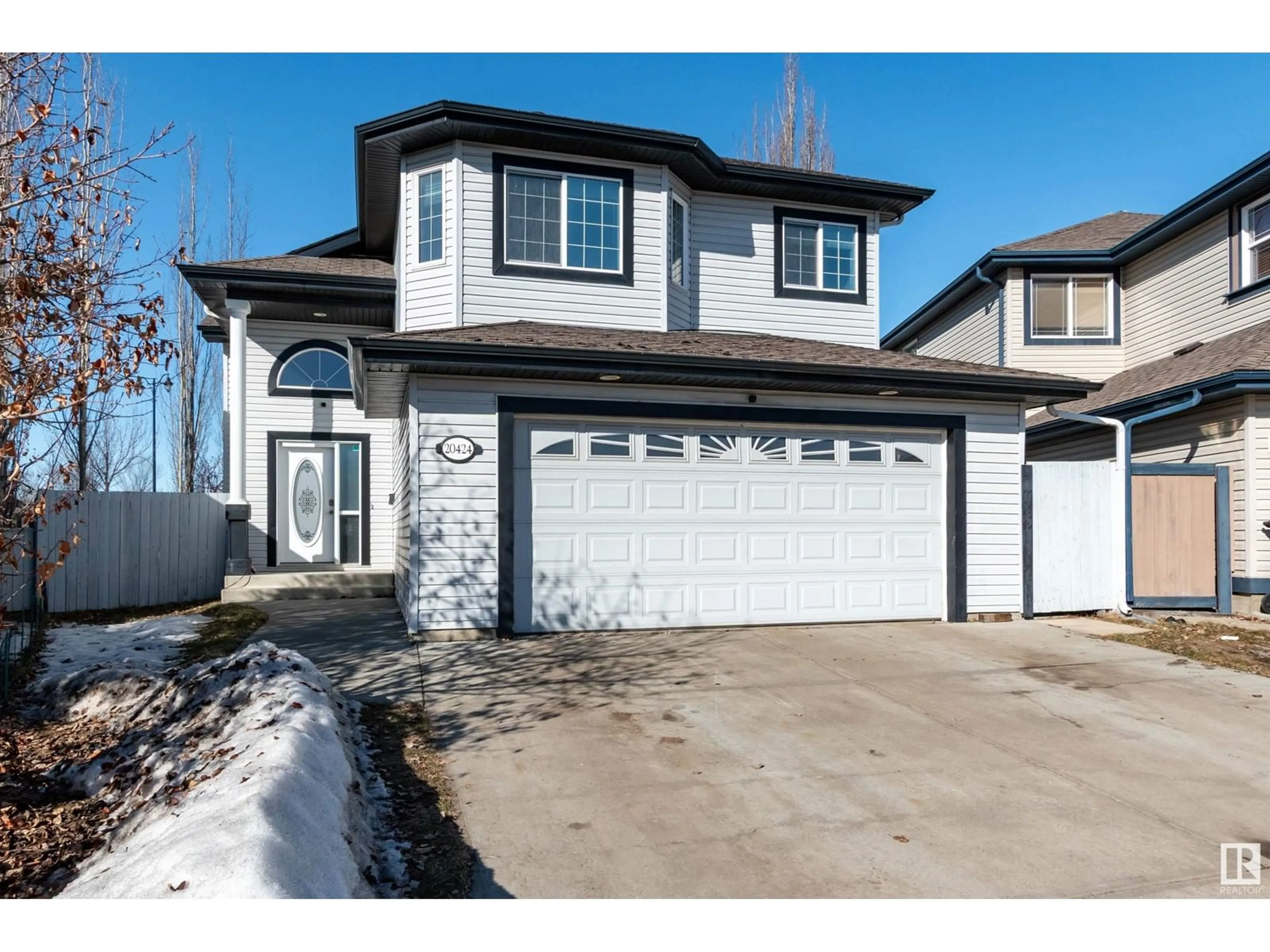 Home with vinyl exterior material, street for 20424 60 AV NW, Edmonton Alberta T6M2Z5