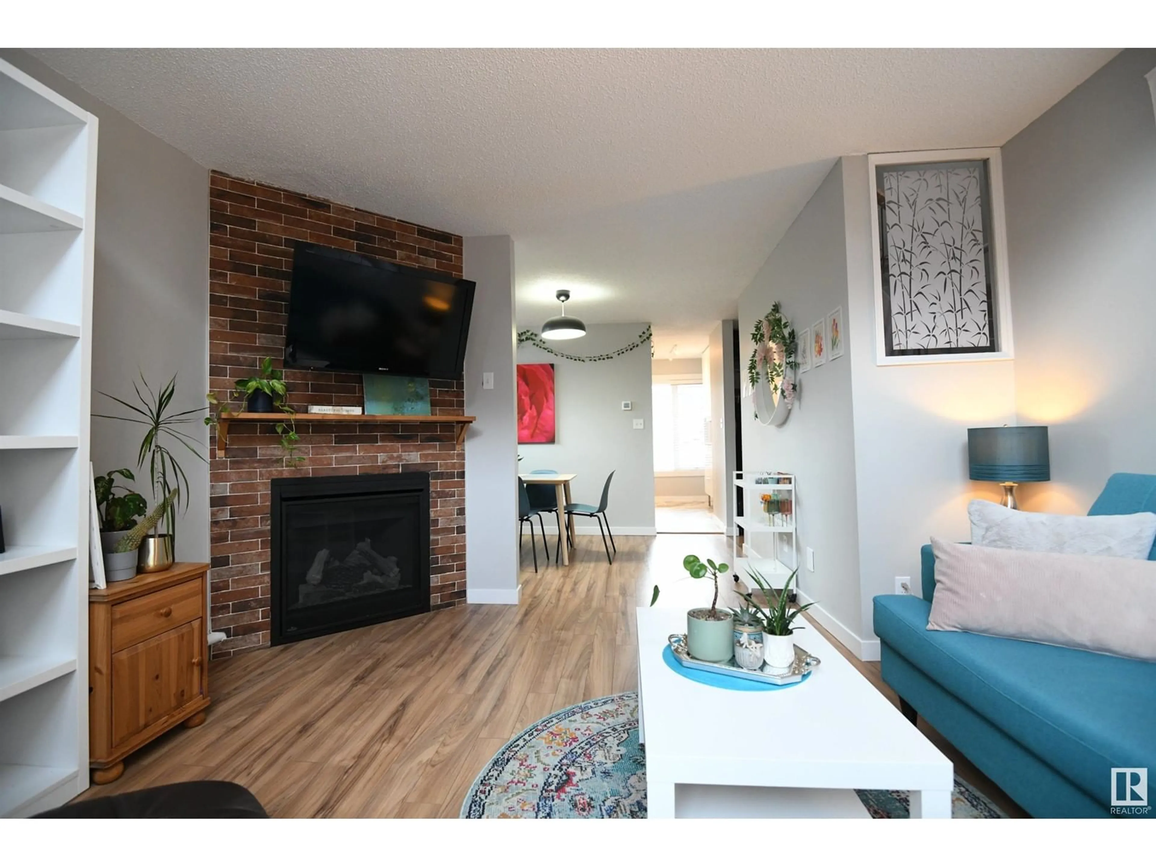 Living room with furniture, wood/laminate floor for #18 11016 86 AV NW, Edmonton Alberta T6G0W9