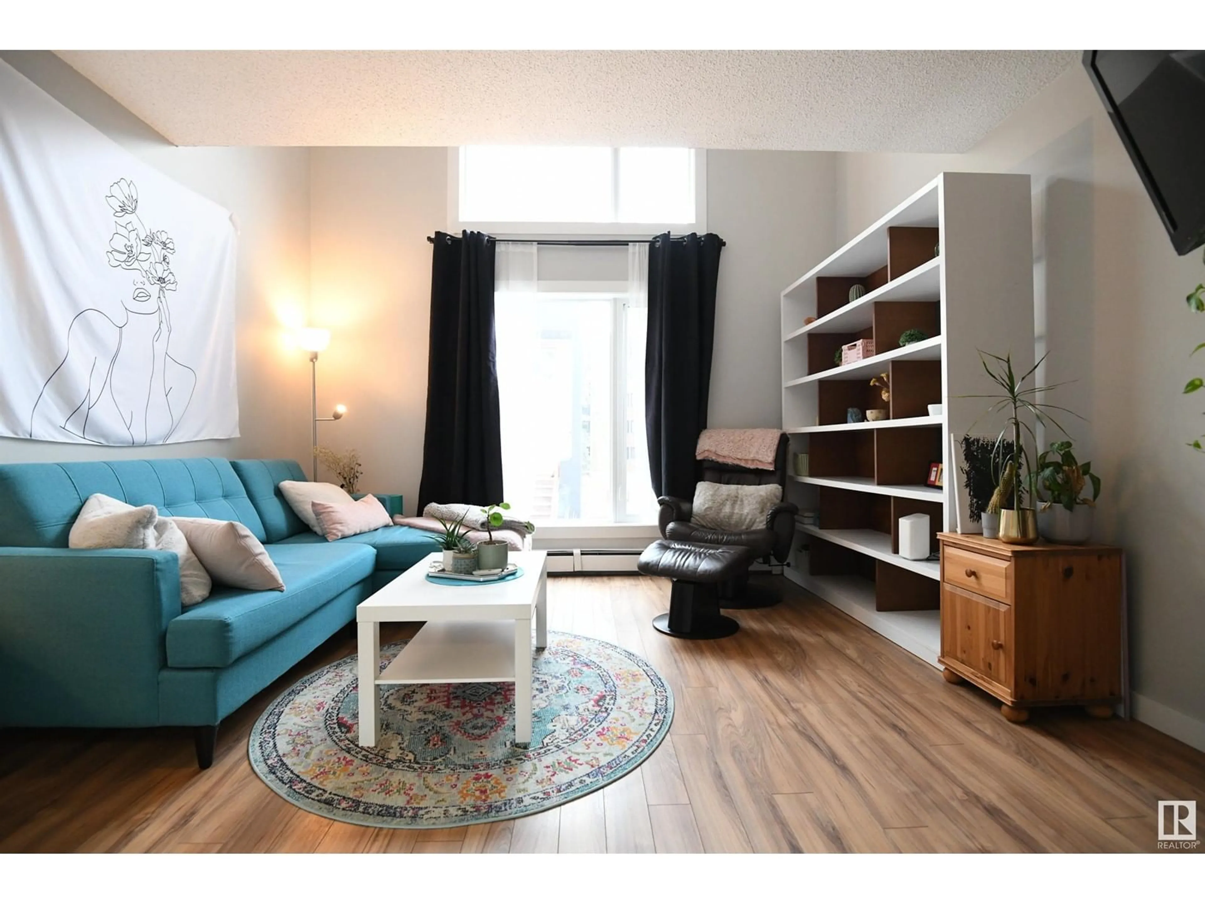 Living room with furniture, wood/laminate floor for #18 11016 86 AV NW, Edmonton Alberta T6G0W9