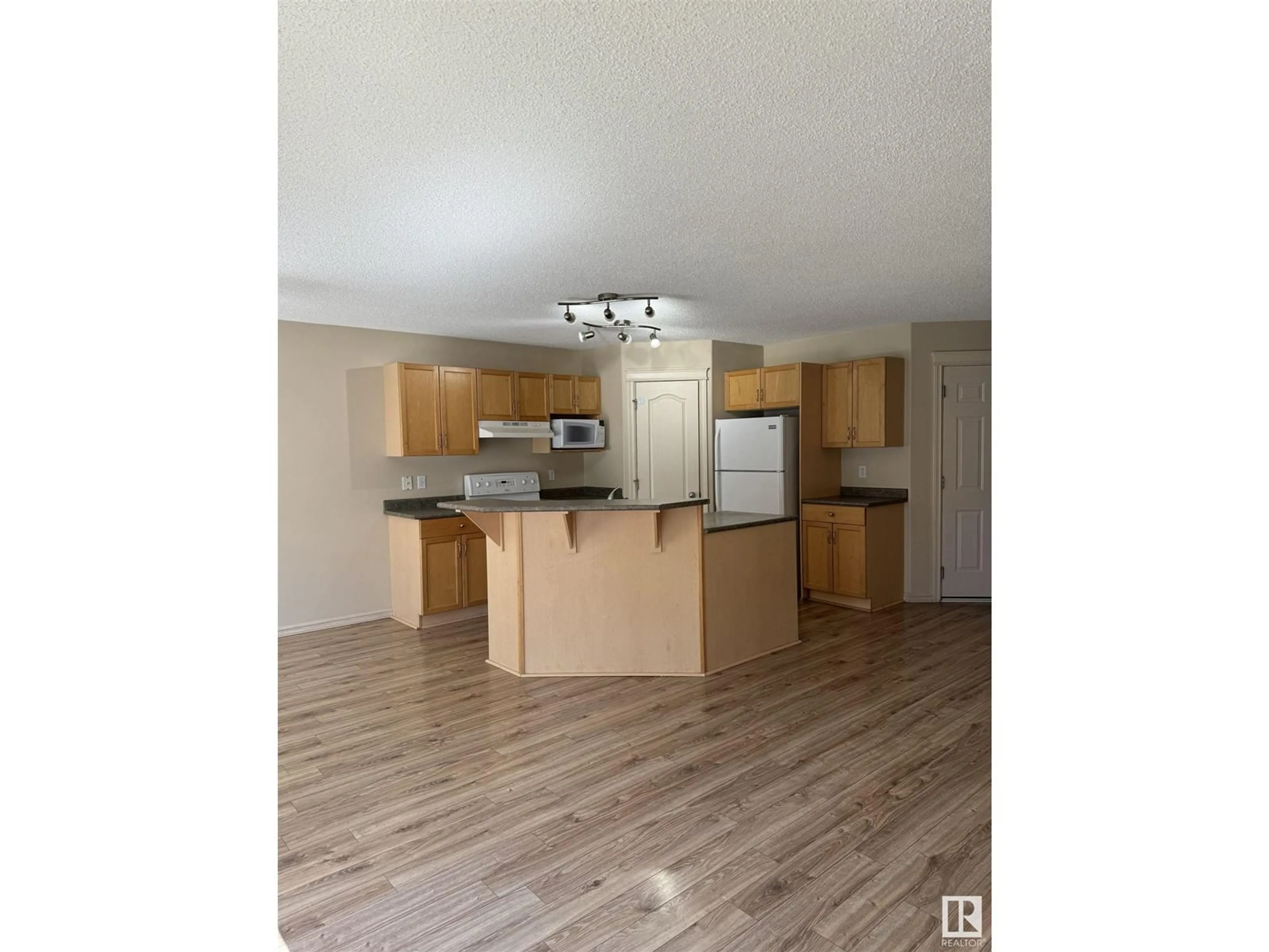 Open concept kitchen, wood/laminate floor for 2534 Rabbit Hill RD NW, Edmonton Alberta T6R2Y9