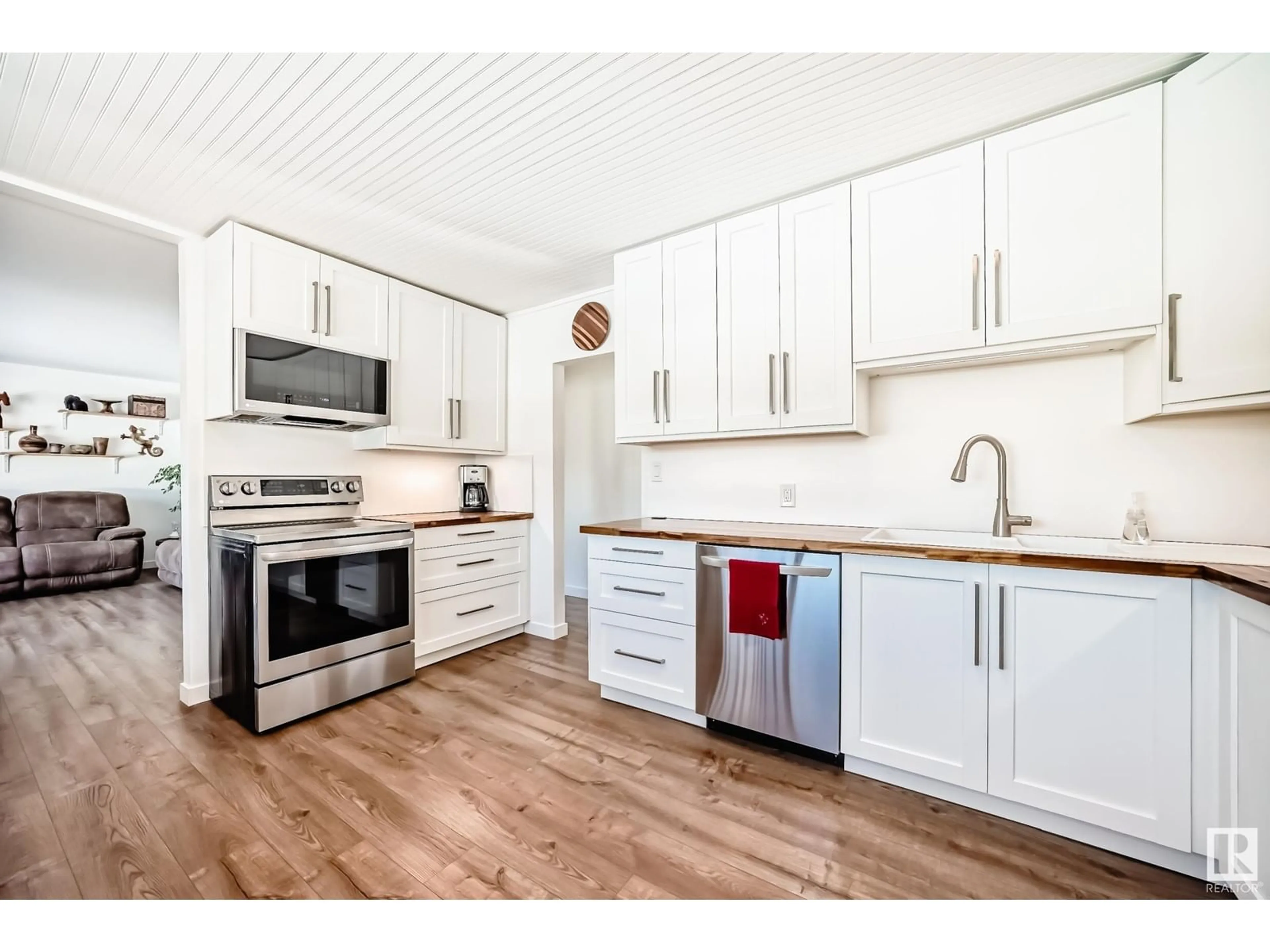 Open concept kitchen, wood/laminate floor for 4925 55 AV, Cynthia Alberta T0E0K0