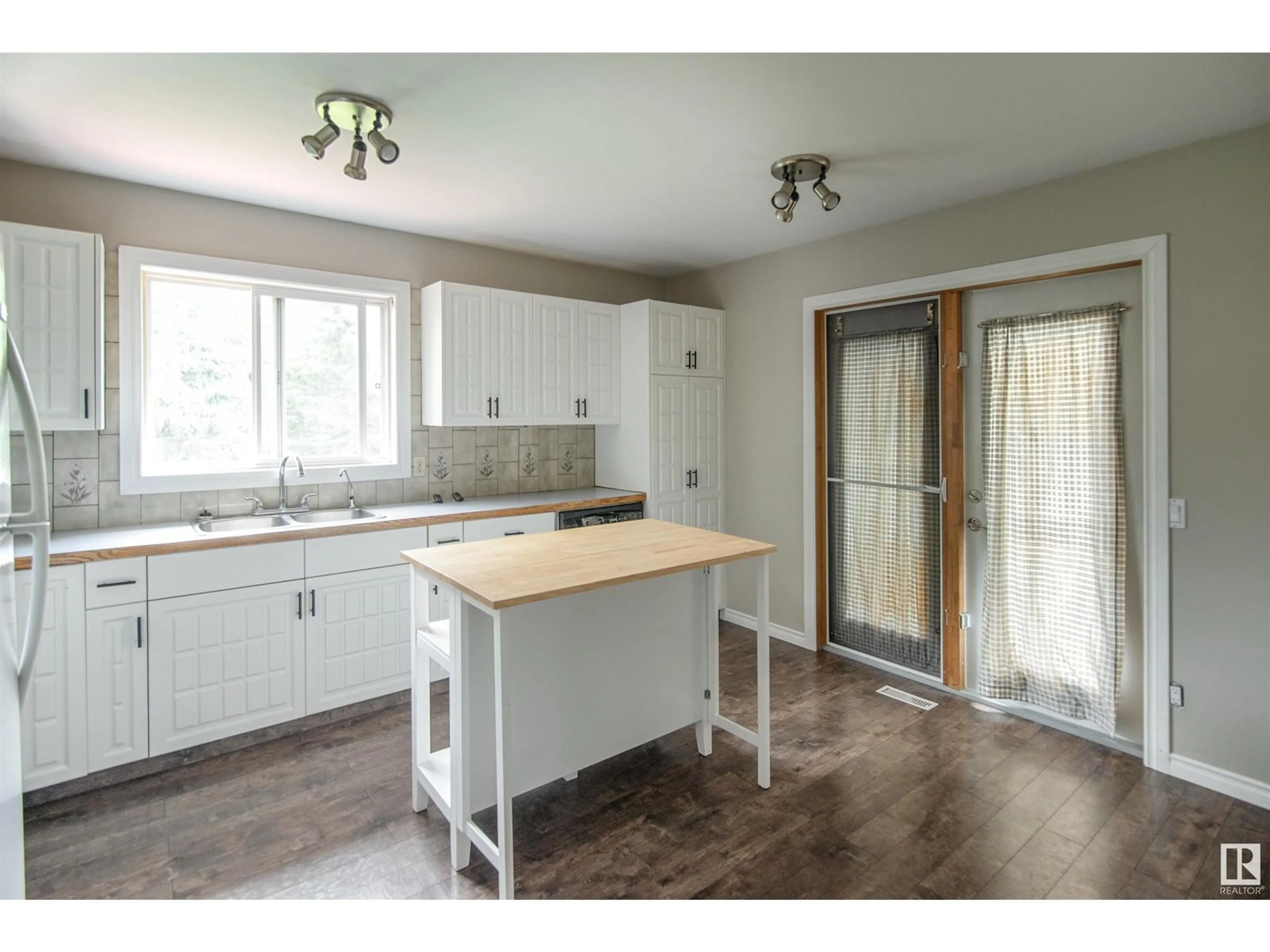 Open concept kitchen, wood/laminate floor for 142 61209 Rg Rd 465, Rural Bonnyville M.D. Alberta T9N2G9