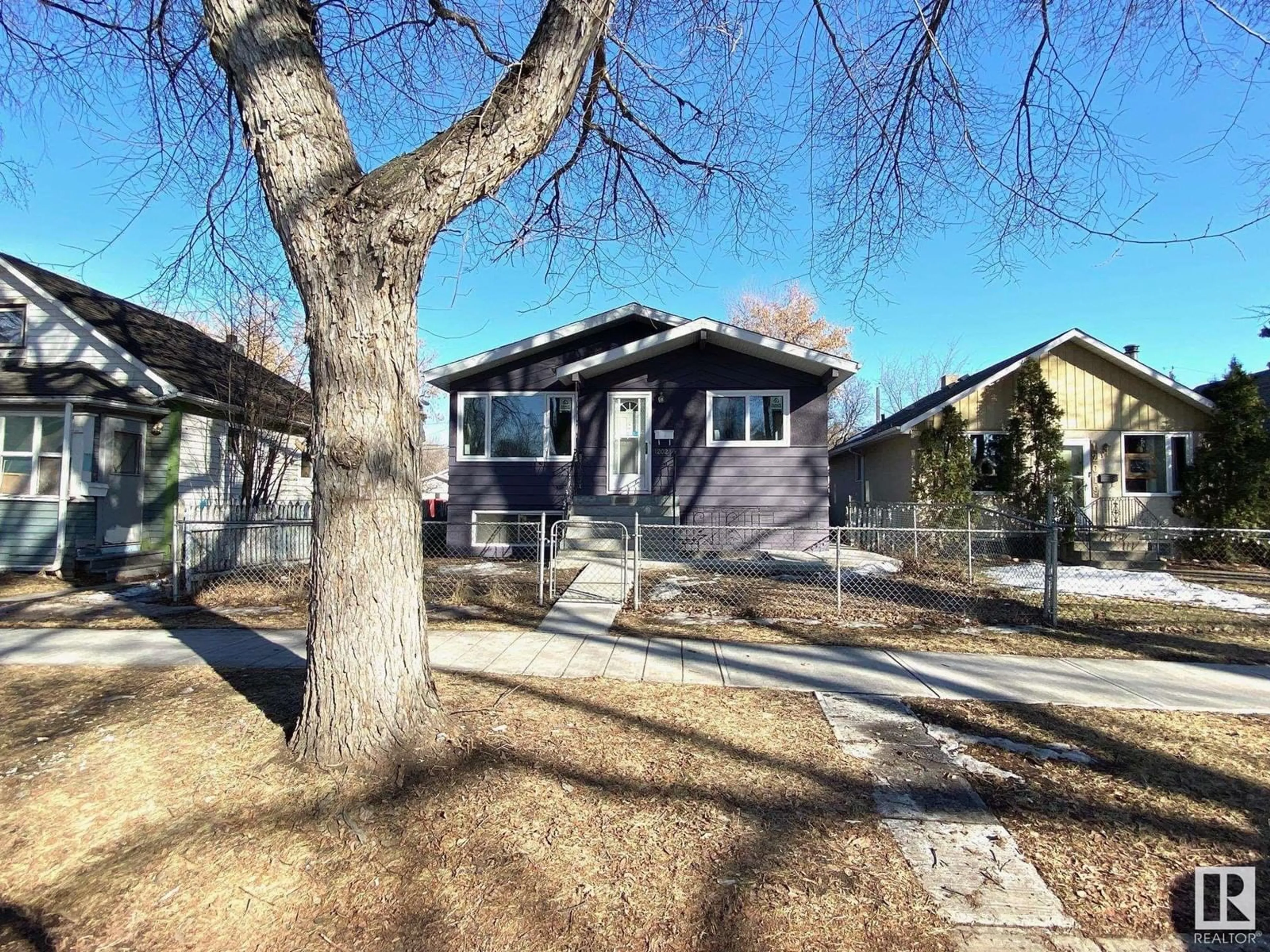 Home with vinyl exterior material, street for 12023 93 ST NW, Edmonton Alberta T5G1G7