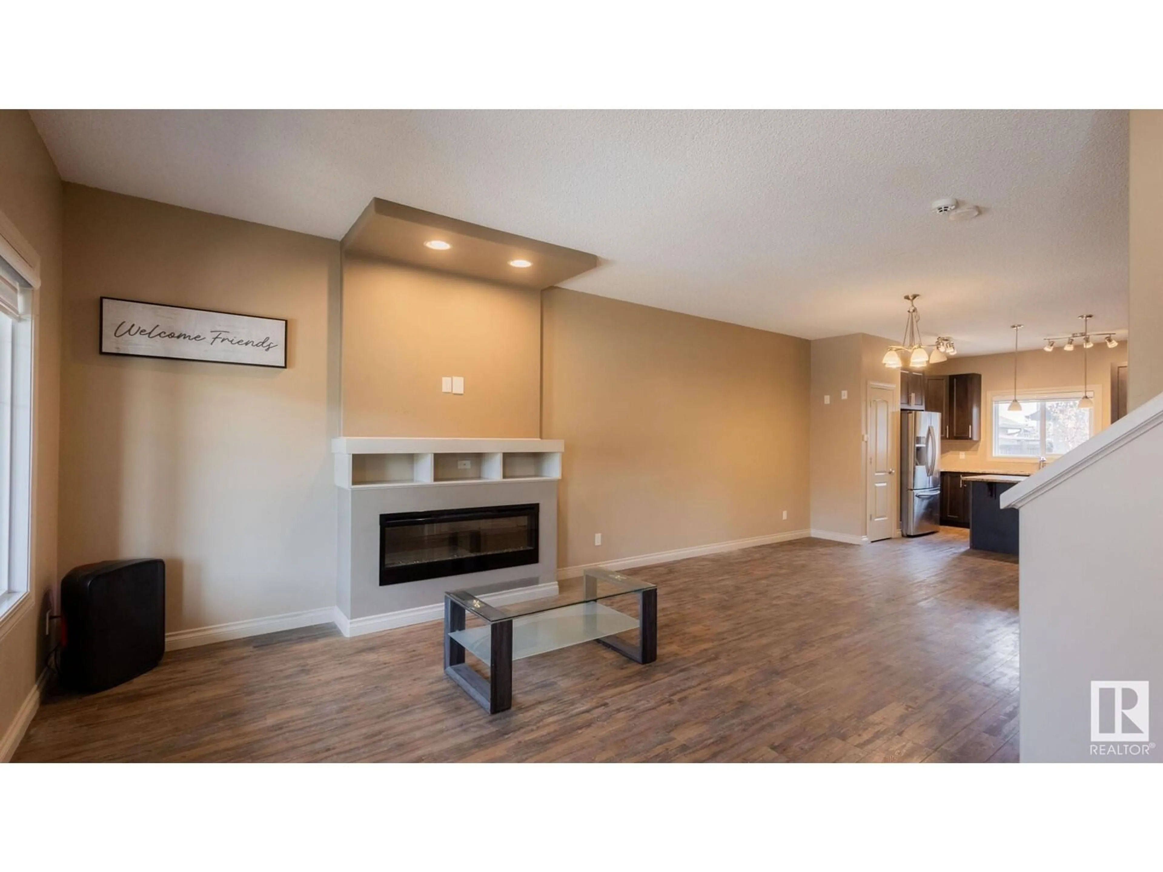 Living room with furniture, wood/laminate floor for 6921 CARDINAL WD SW, Edmonton Alberta T6W2Y3