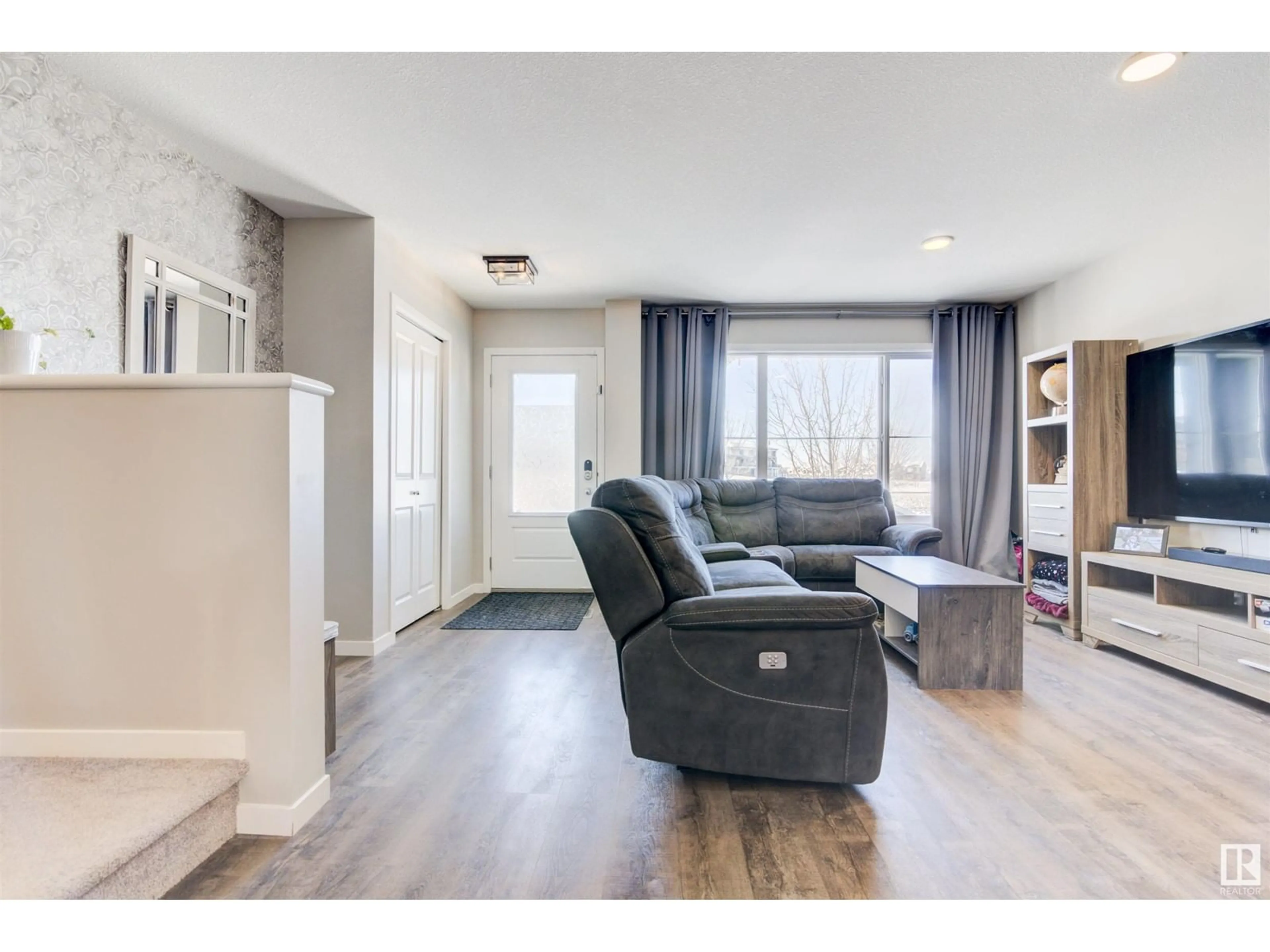 Living room with furniture, wood/laminate floor for 1049 PAISLEY DR SW, Edmonton Alberta T6W4E1