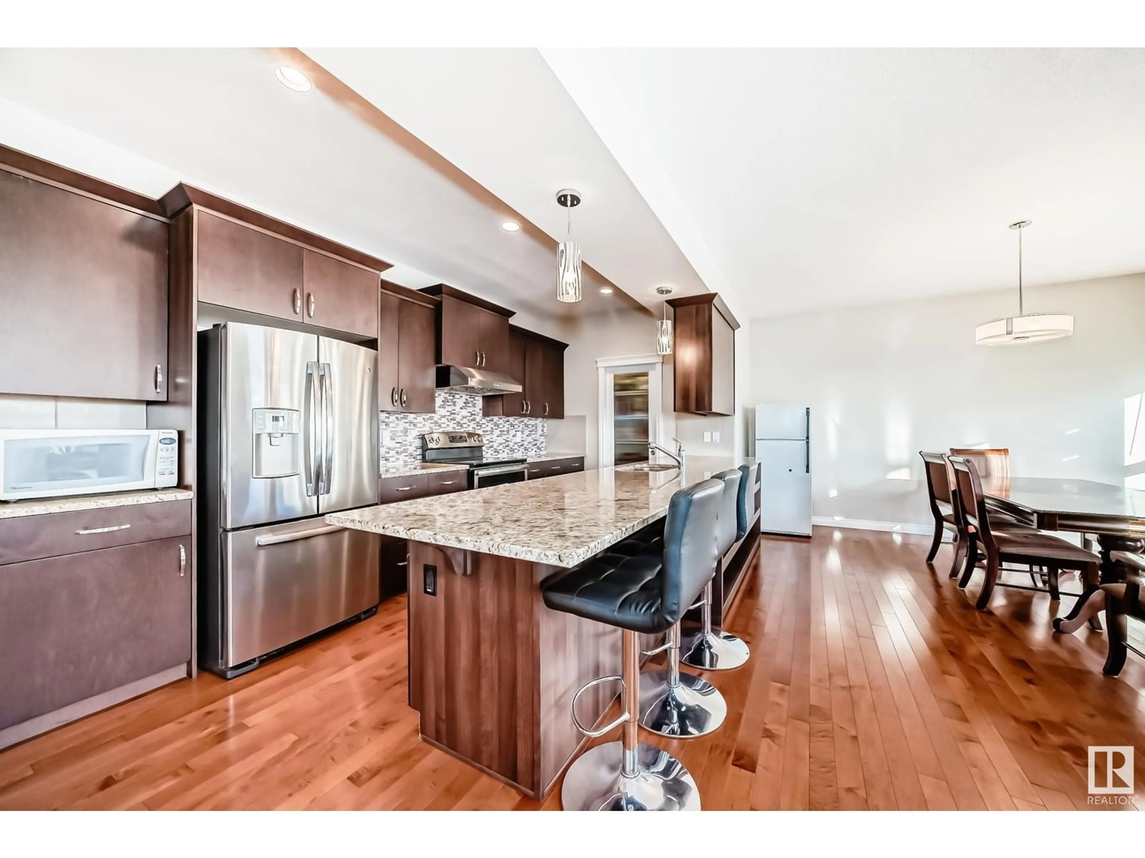 Open concept kitchen, wood/laminate floor for 13815 142 AV NW NW, Edmonton Alberta T6V0L6