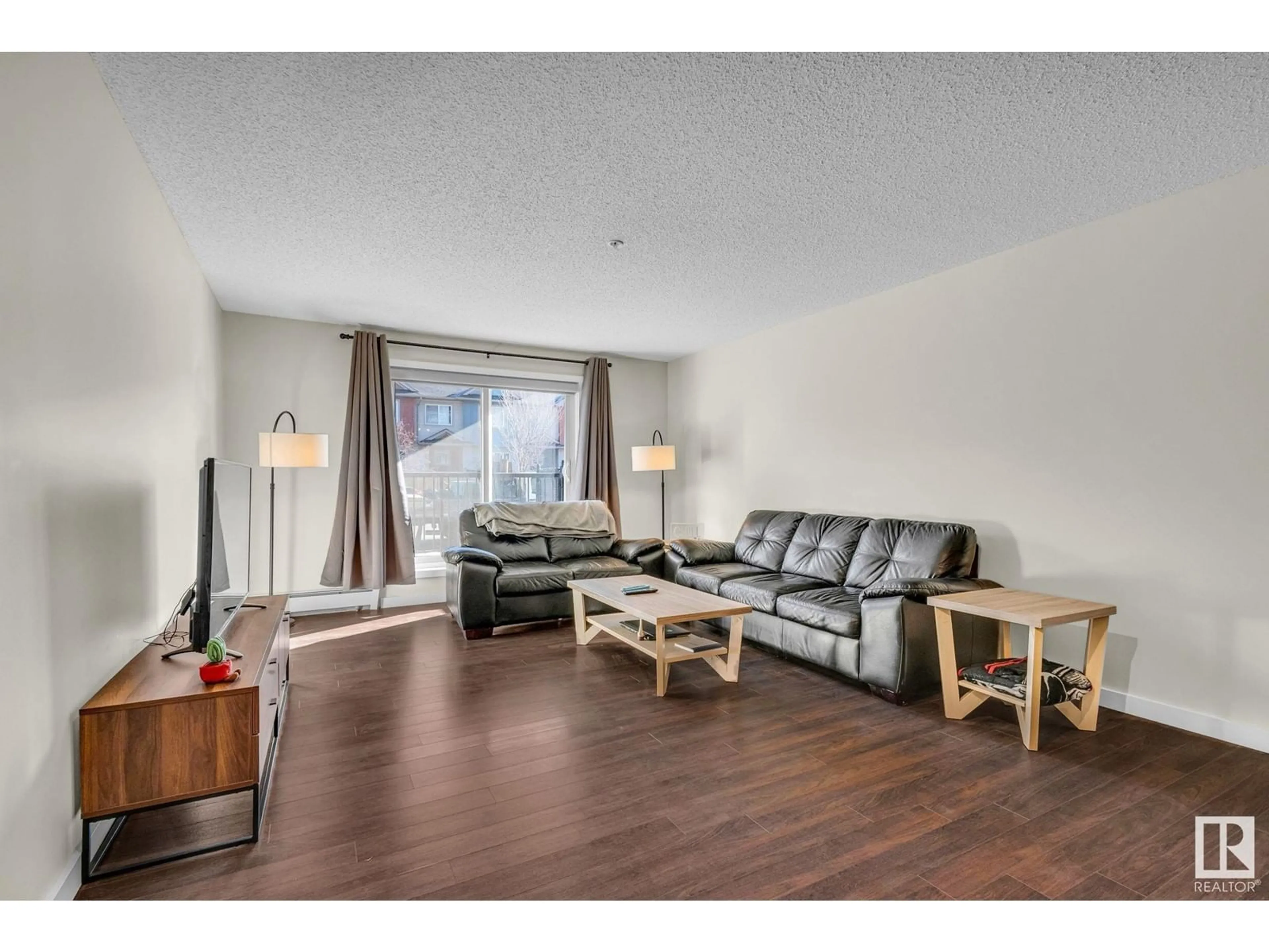 Living room with furniture, wood/laminate floor for #106 - 14808 125 ST, Edmonton Alberta T5X0G1