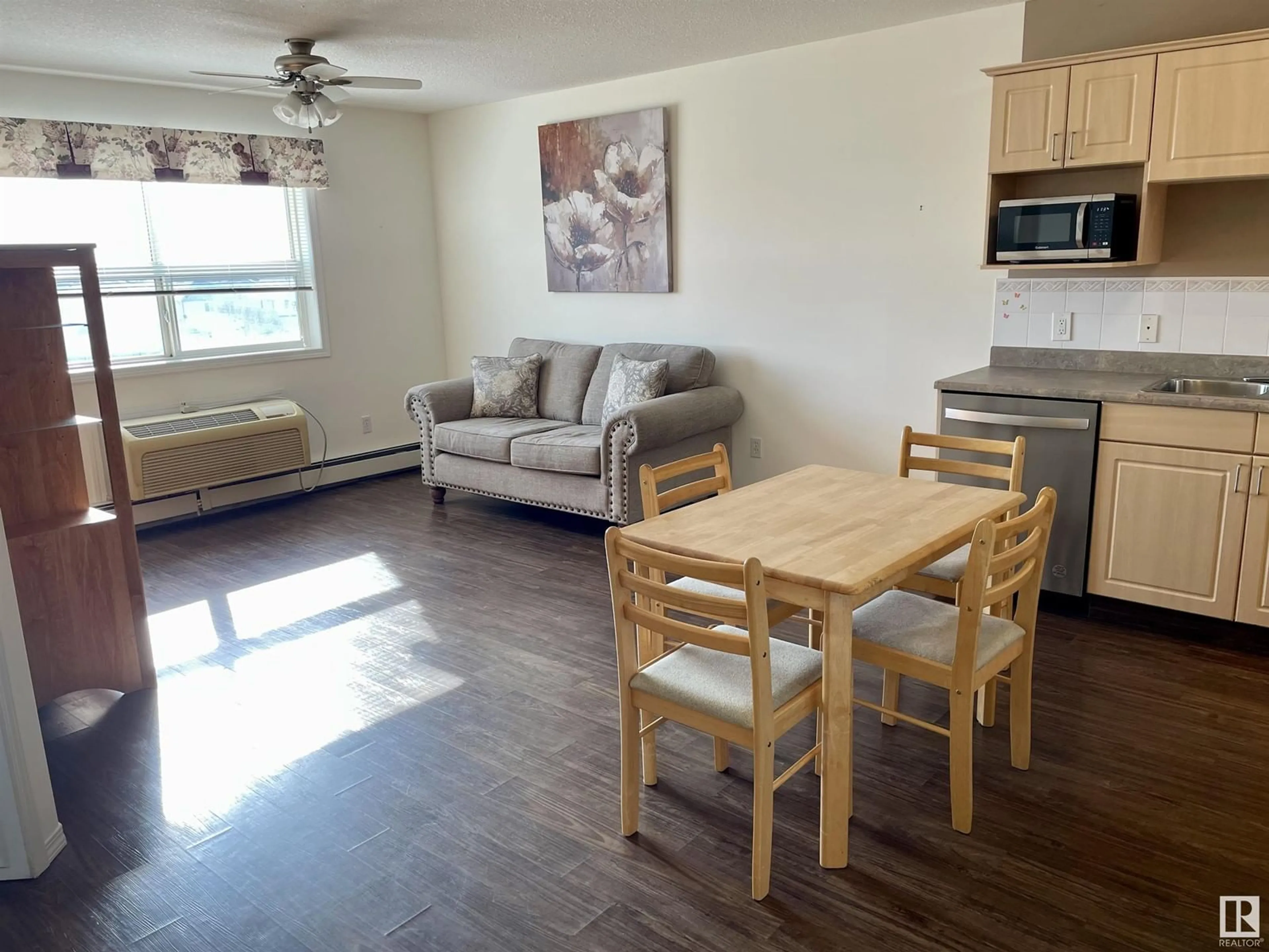 Living room with furniture, wood/laminate floor for #413 8802 SOUTHFORT DR, Fort Saskatchewan Alberta T8L4R6