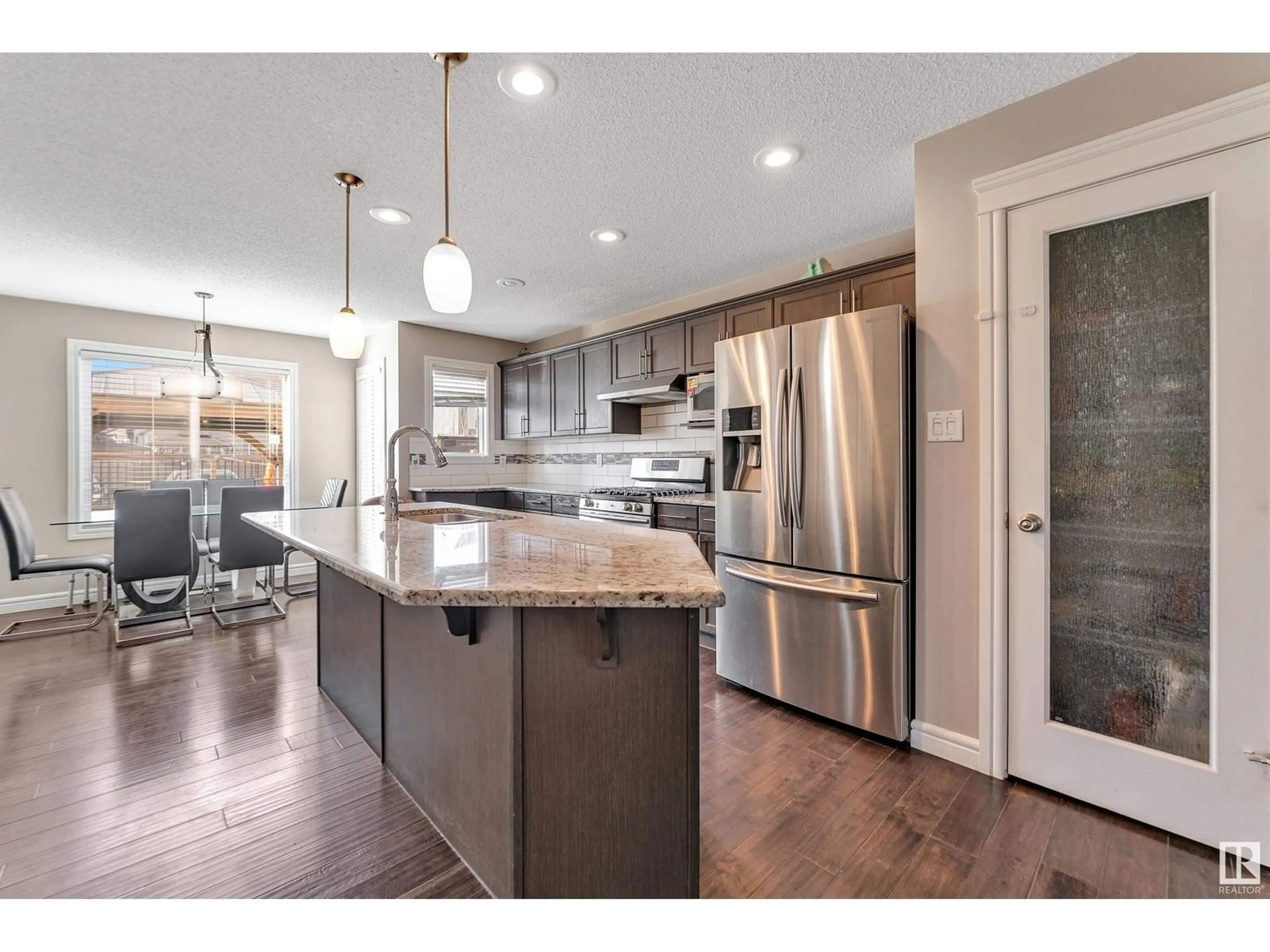 Open concept kitchen, wood/laminate floor for 3035 14 AV NW, Edmonton Alberta T6T0Z2